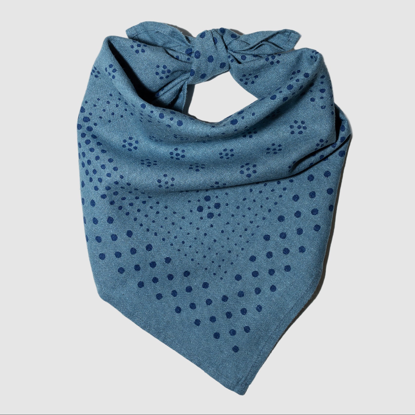 Blue bandana with a pattern on a gray background
