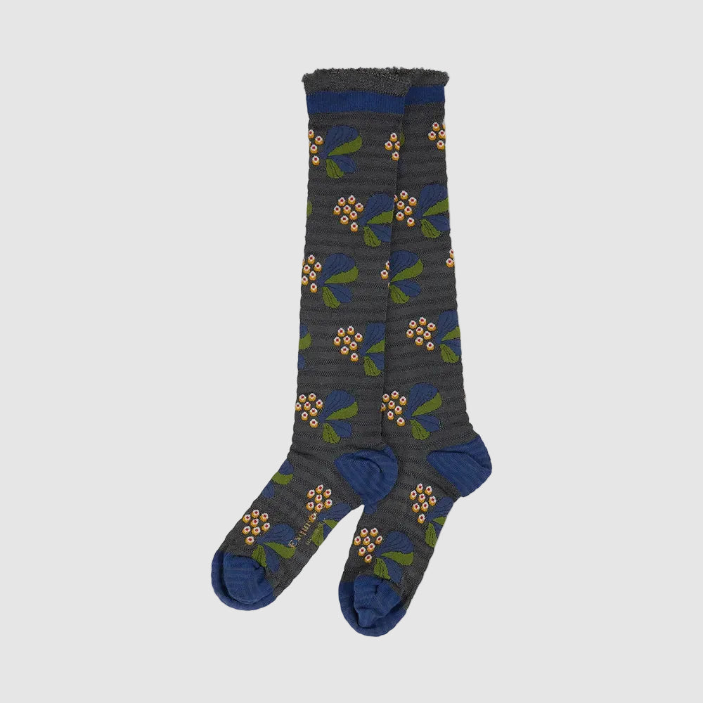 A pair of dark gray ribbed socks with a blue, green, and orange floral pattern, featuring solid blue heels, toes, and cuffs, displayed against a light gray background.