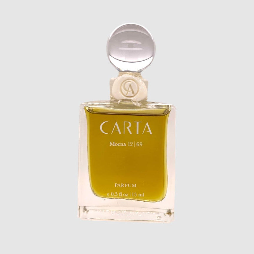 A clear glass perfume bottle with a silver cap, labeled 'Carta Moena 15ml Parfum'.