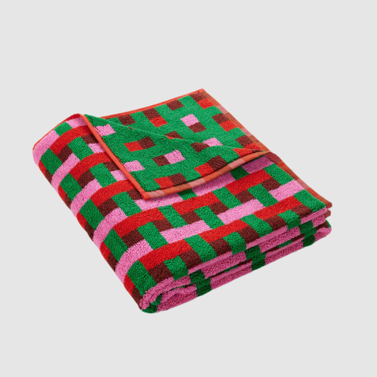 Dusen Dusen Bath Towel, Weave, green, red, pink burgundy folded on subway tiles