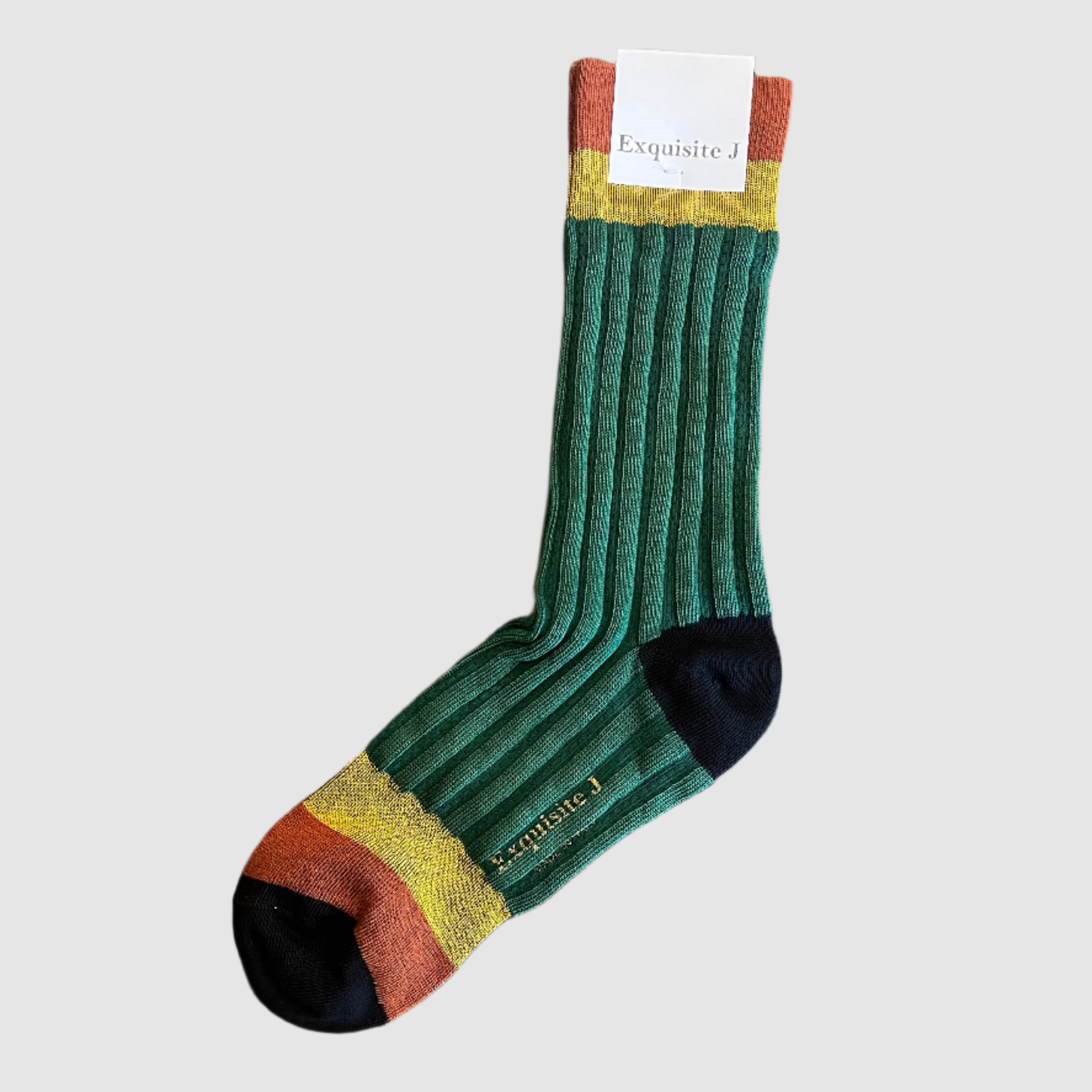 Green sock with brown and yellow accents on a wooden surface