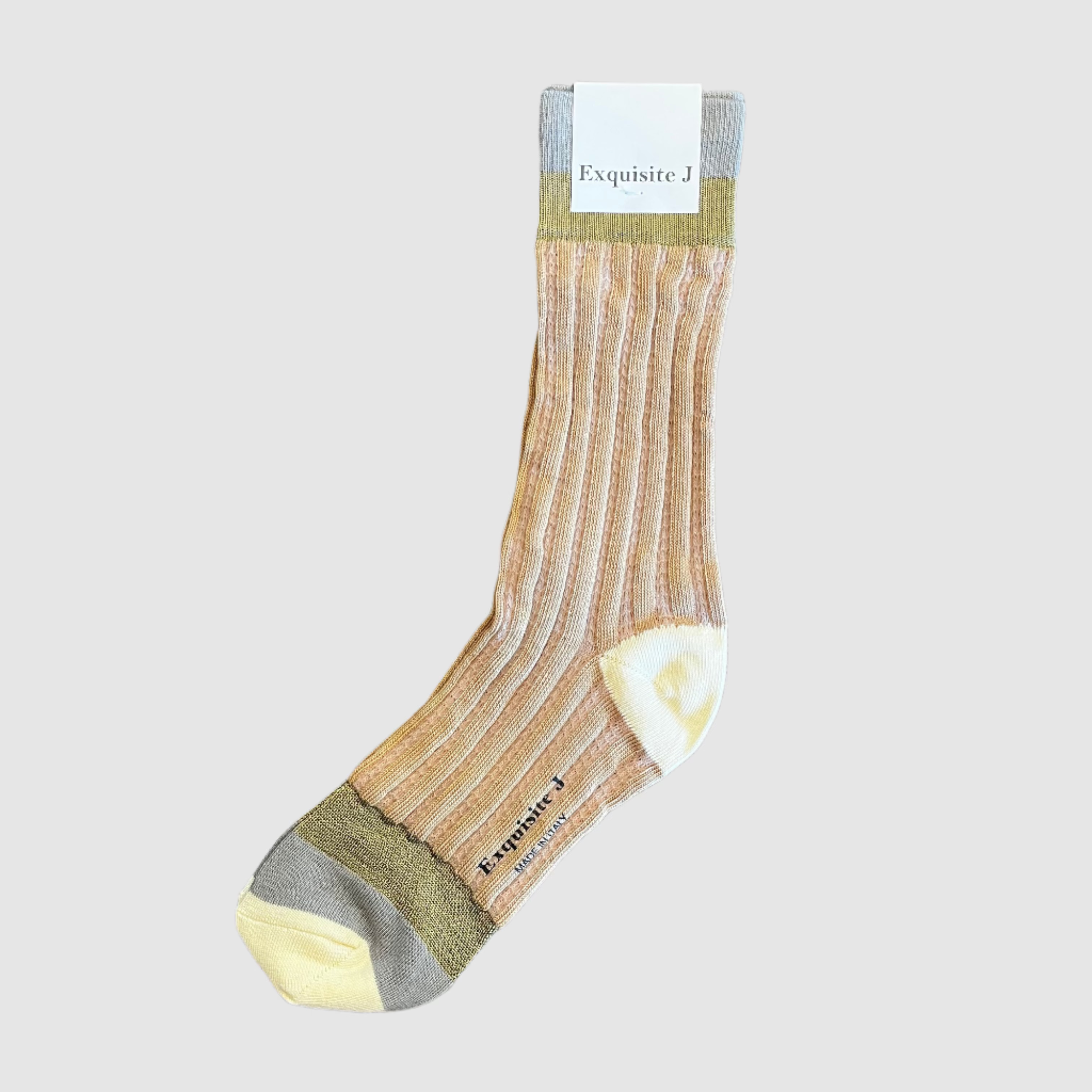 Beige sock with a visible brand label on a wooden surface