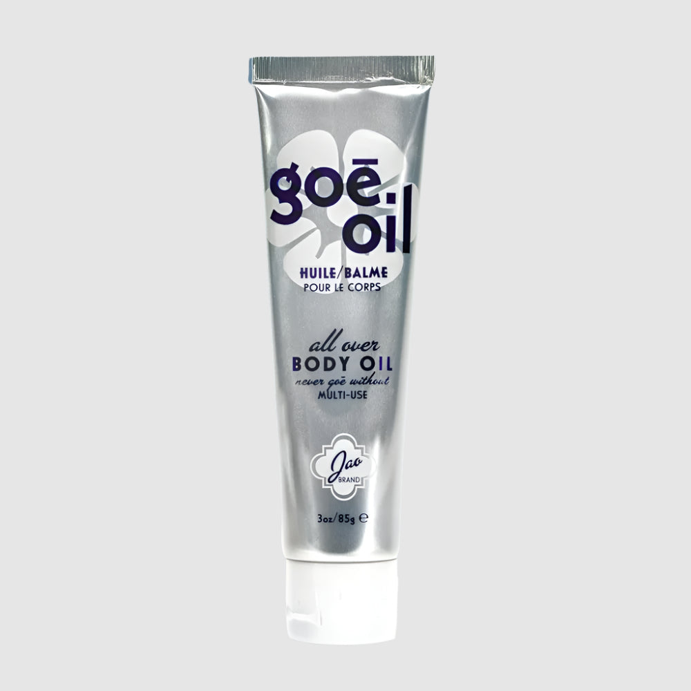 A tube of GOÉ OIL body oil with a white and silver design, indicating that it is a product for the body.