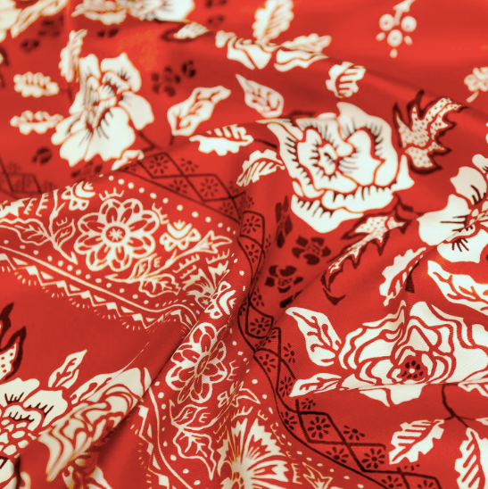 red silk and twill bandana with white floral, geometric pattern printed on top