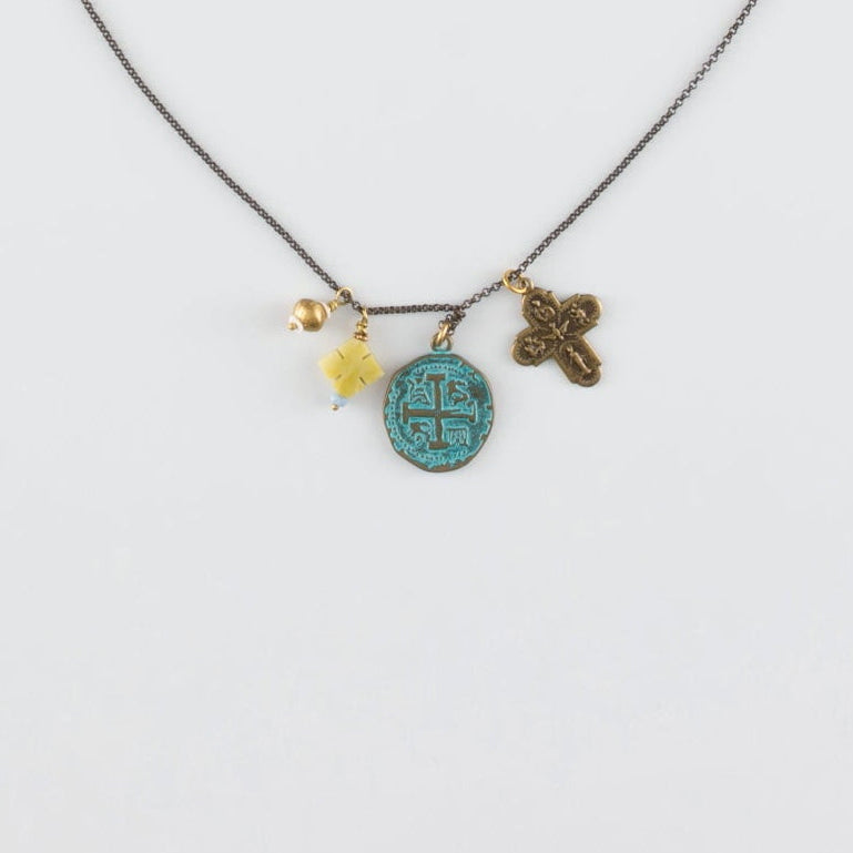 Necklace with charms on a light gray background