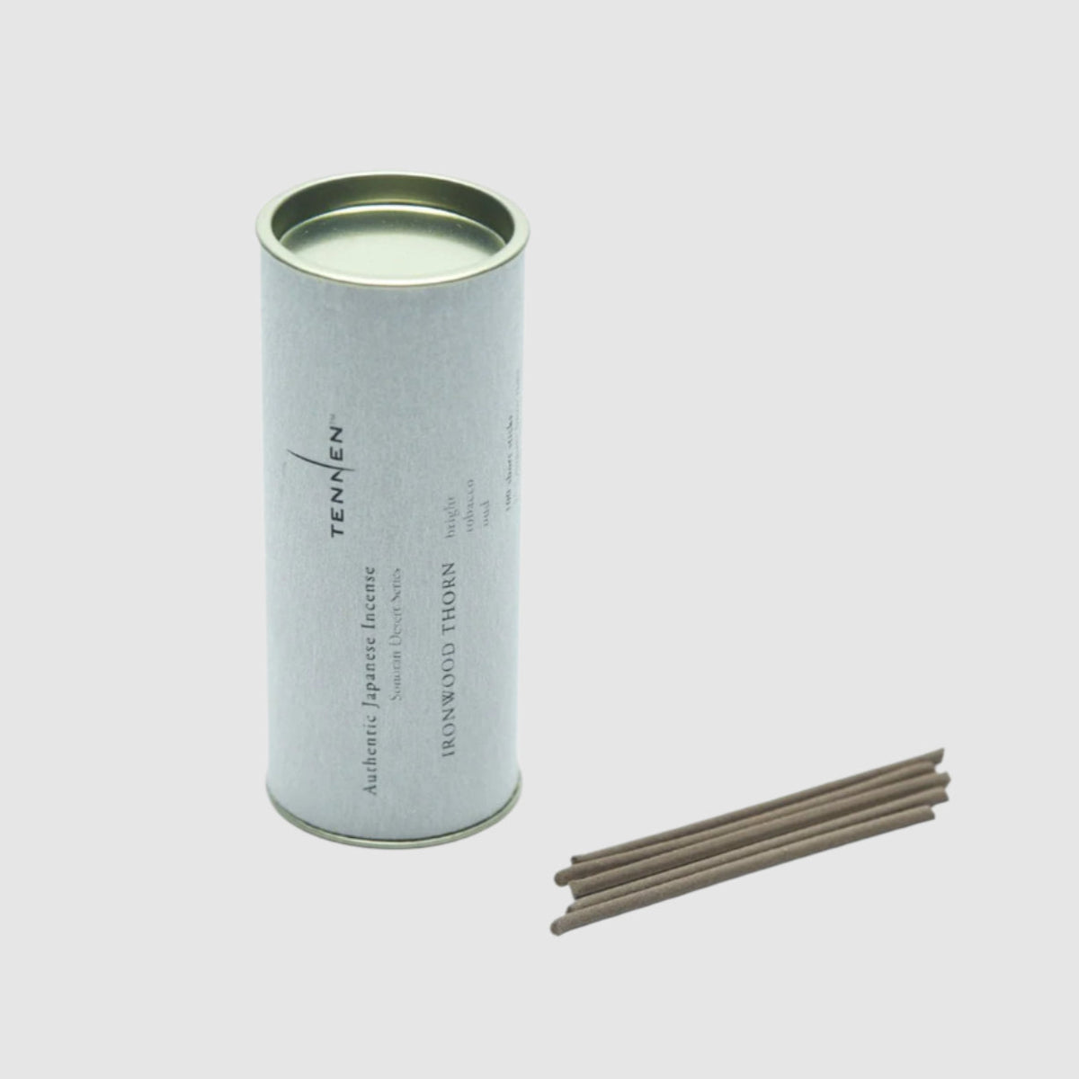 Tennen incense stick canister with incense sticks on a light gray background
