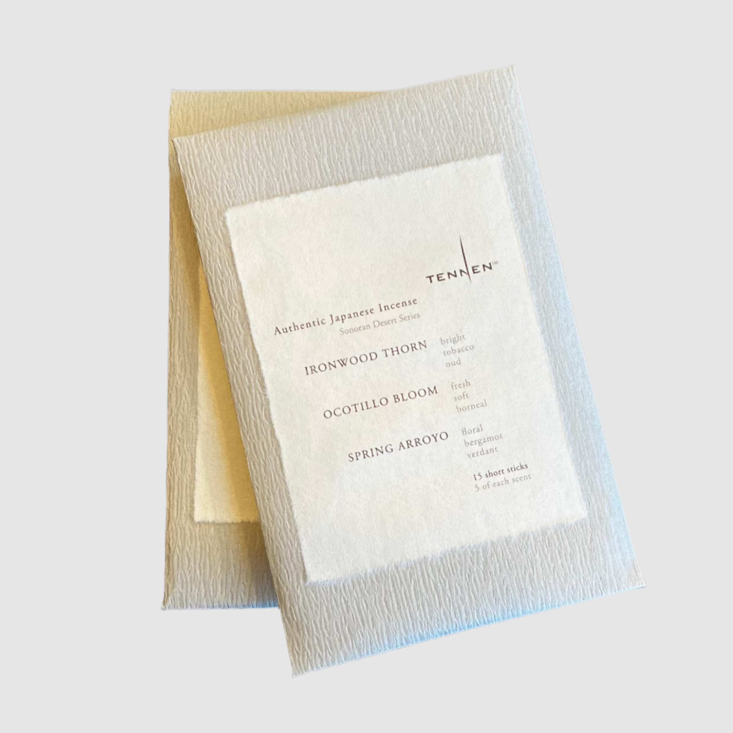 Two packets of the Tennen Sonoran Desert Mix Incense on a grey background.