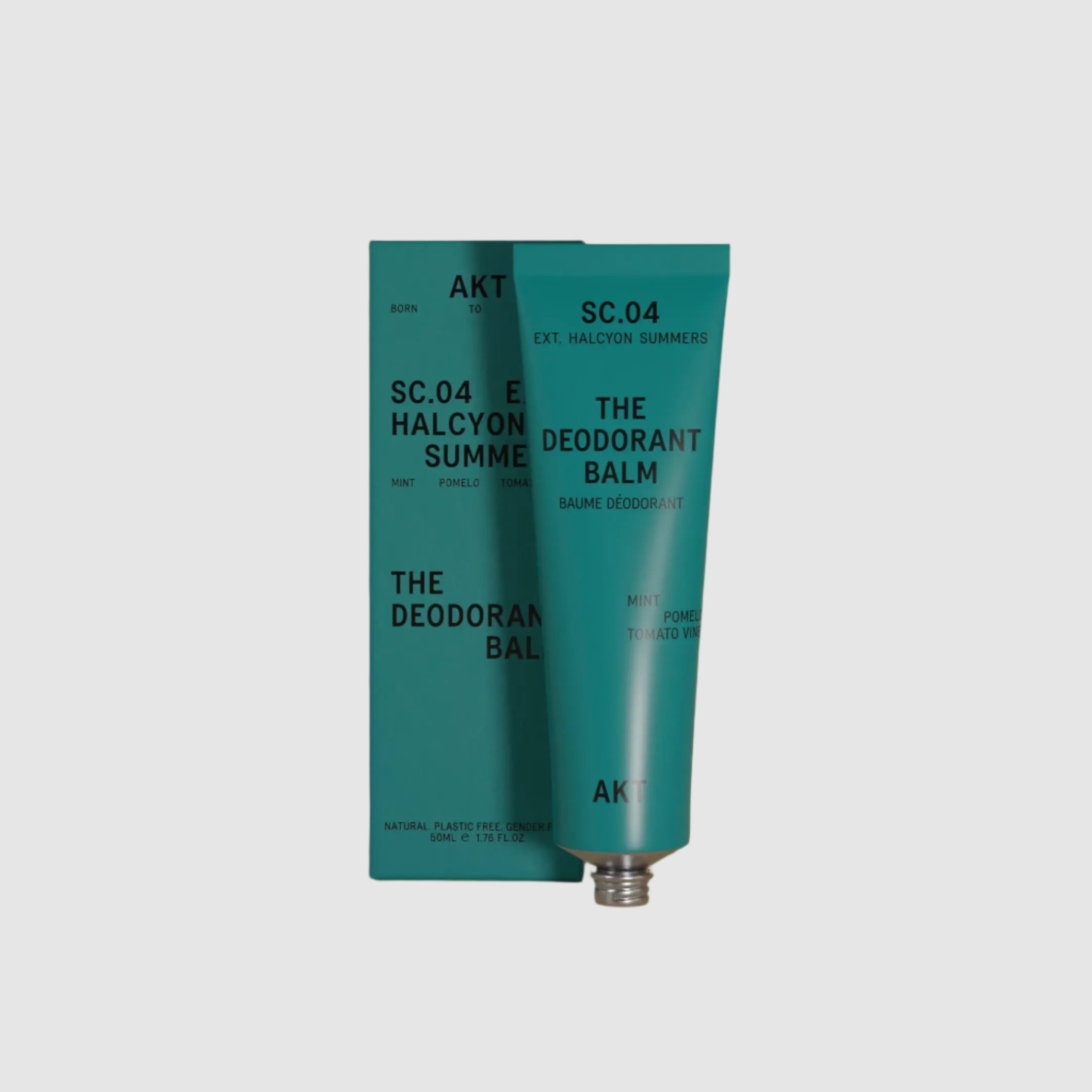Two teal tubes of 'The Deodorant Balm' on a beige background