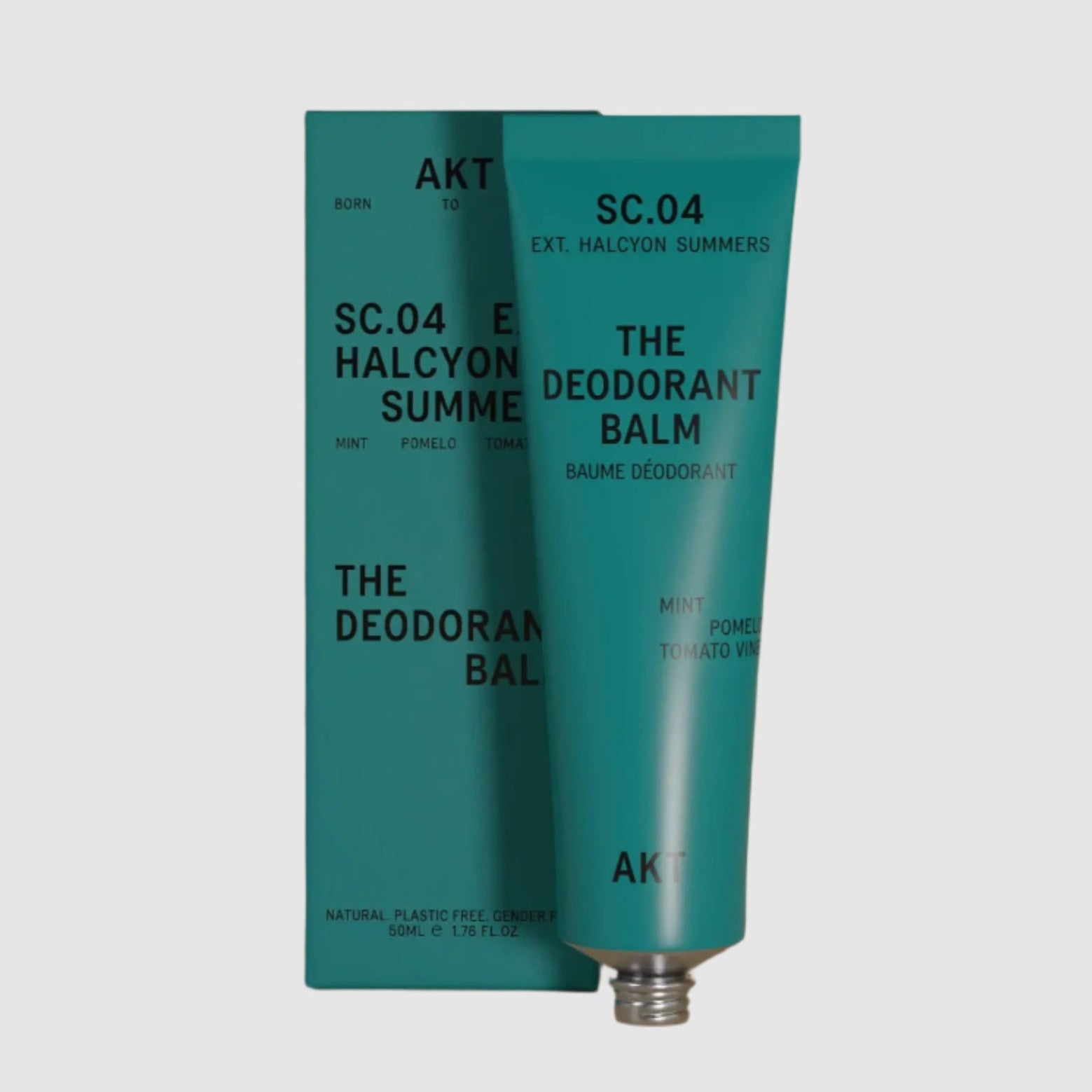 Teal deodorant balm with packaging on a light gray background
