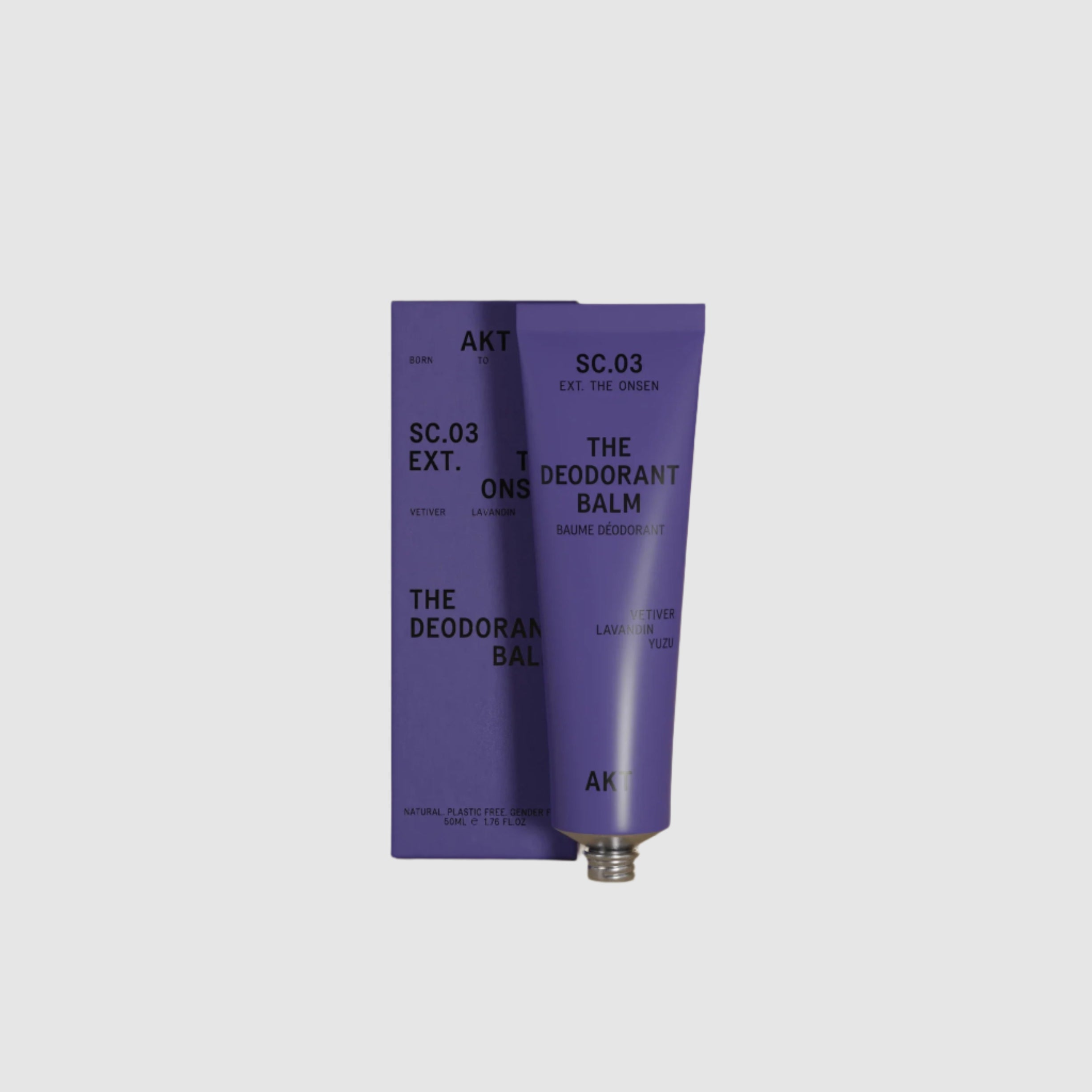 Purple deodorant balm with packaging on a beige background