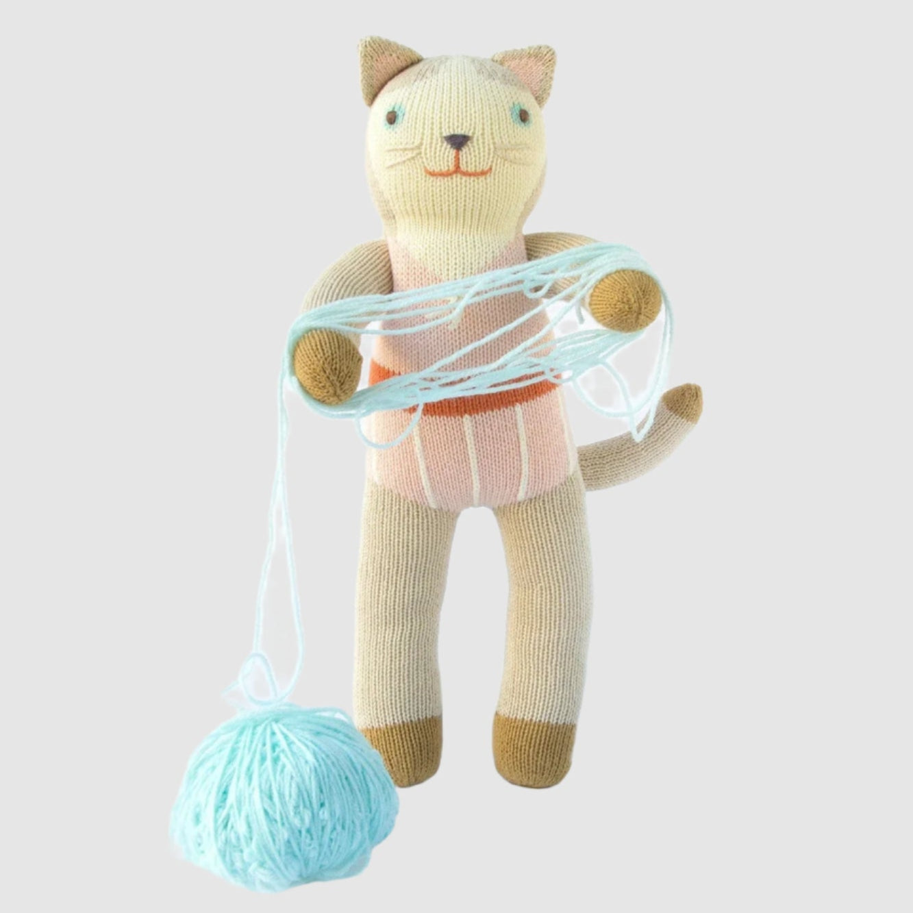 Knitted cat toy with yarn on a white background