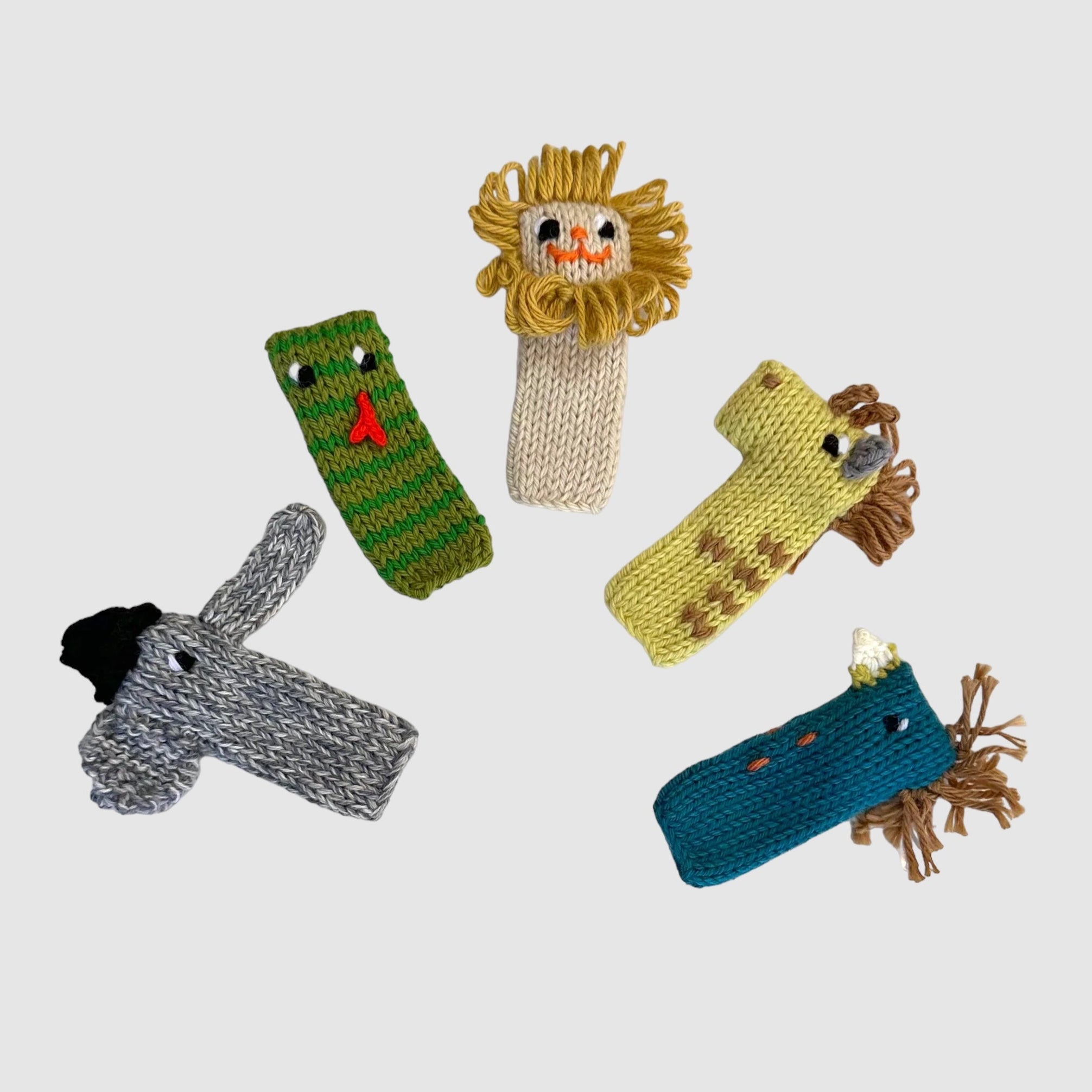A set of five colorful finger puppets designed to look like animals from the jungle, including an elephant, lion, snake, giraffe, and bird.