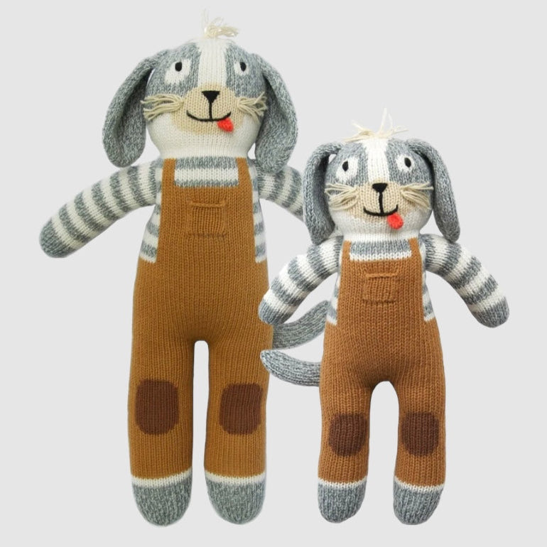 Two knit dolls designed to look like dogs, with striped overalls and patch details, one larger and one smaller.
