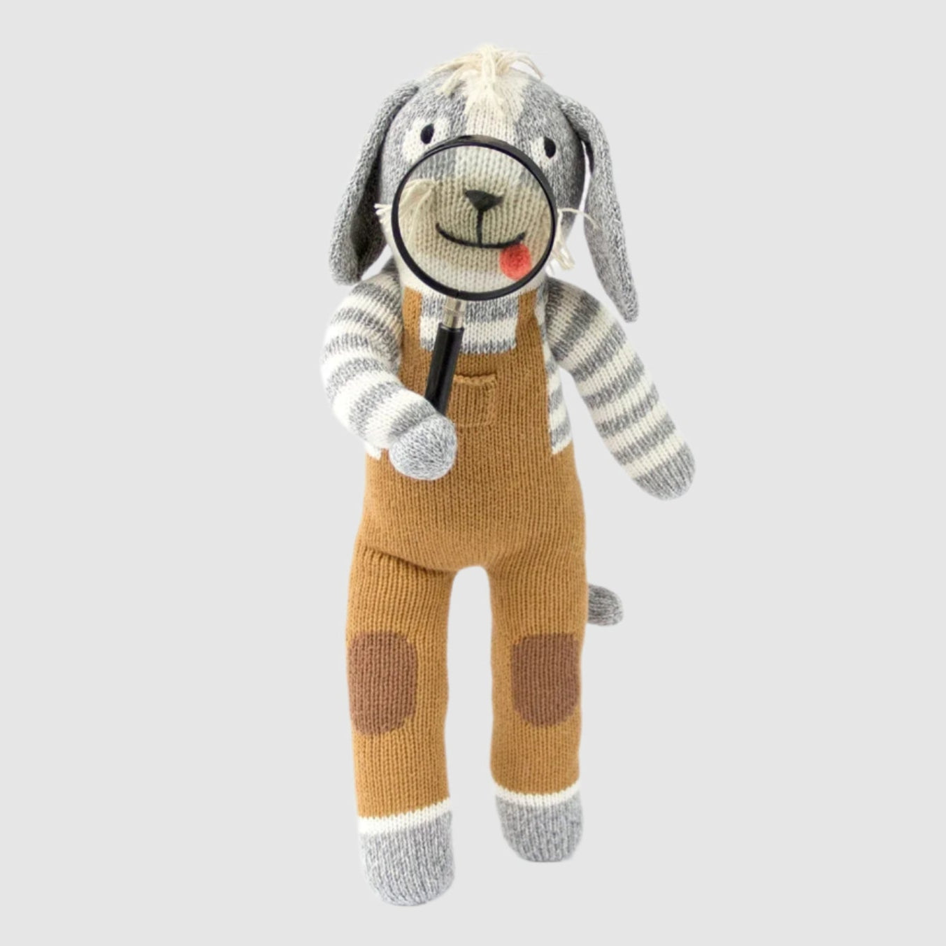 Knitted dog toy with a magnifying glass on a white background