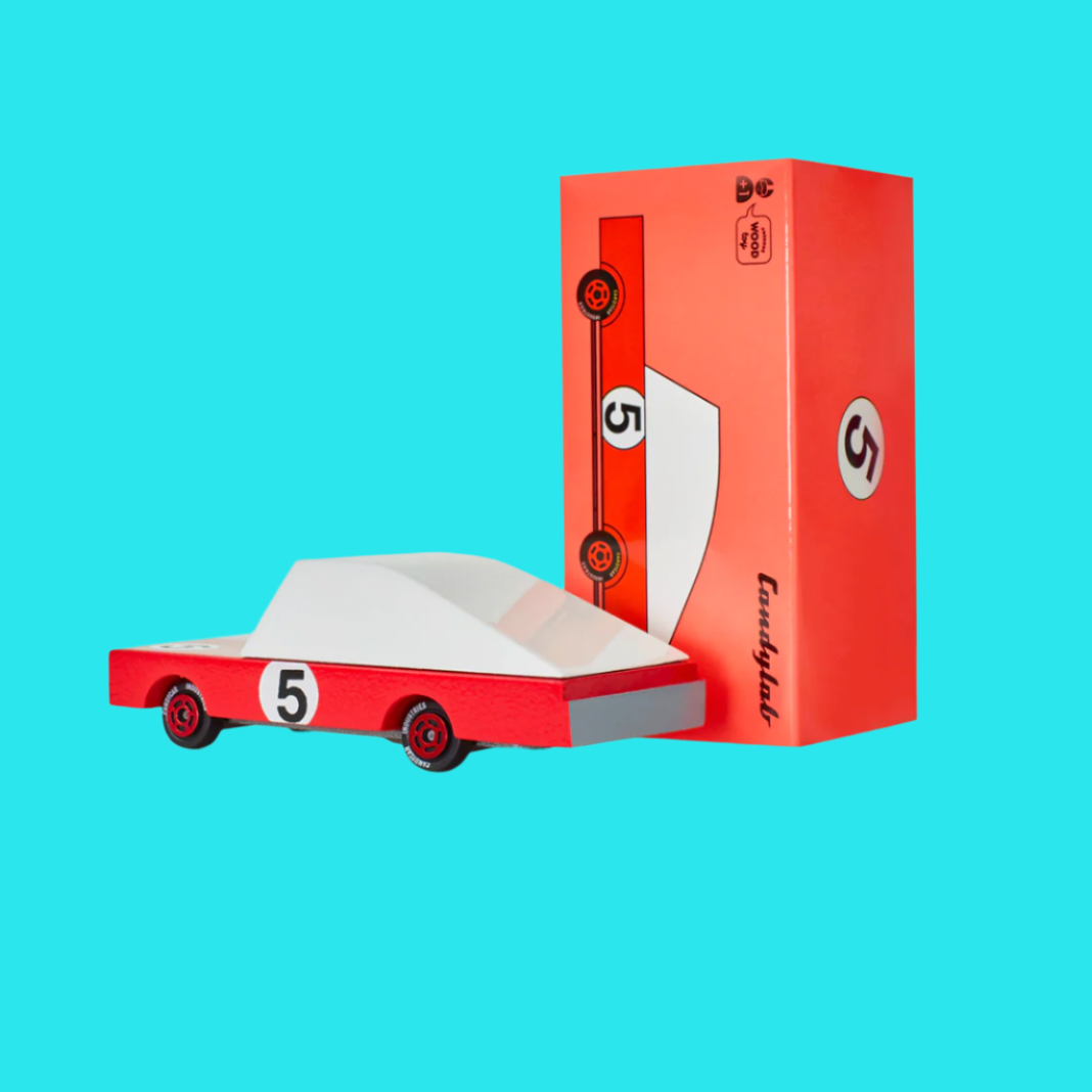 Red toy car with white top and number 5, next to its packaging box on a blue background