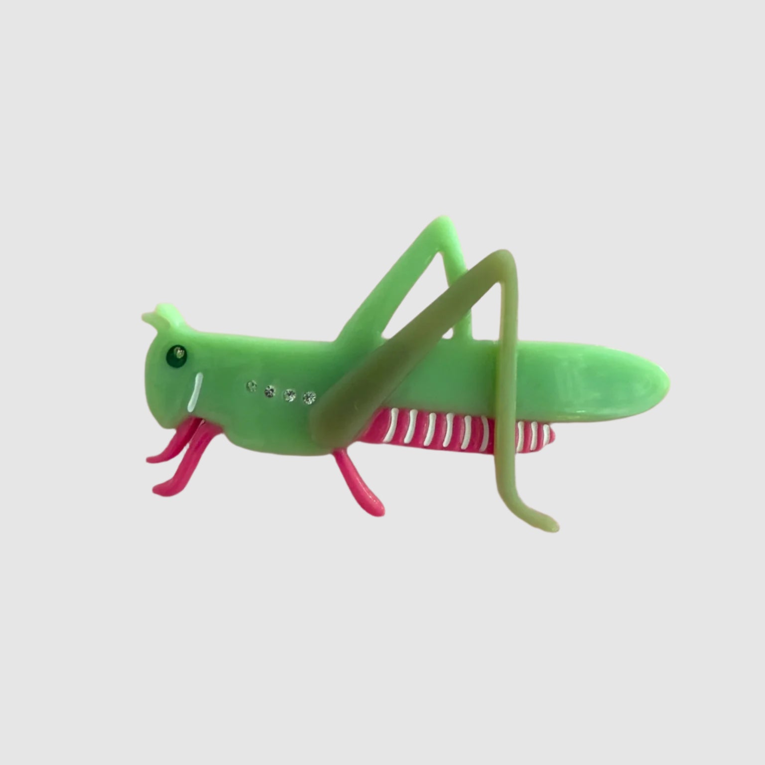 A 'cricket' style Centinelle barrette on a light grey background