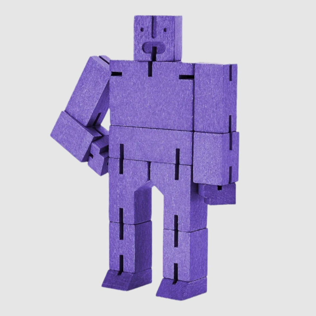 Purple robot toy made of interlocking blocks on a white background