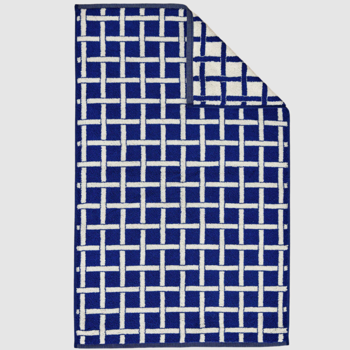 Blue and white checkered towel on a beige textured surface