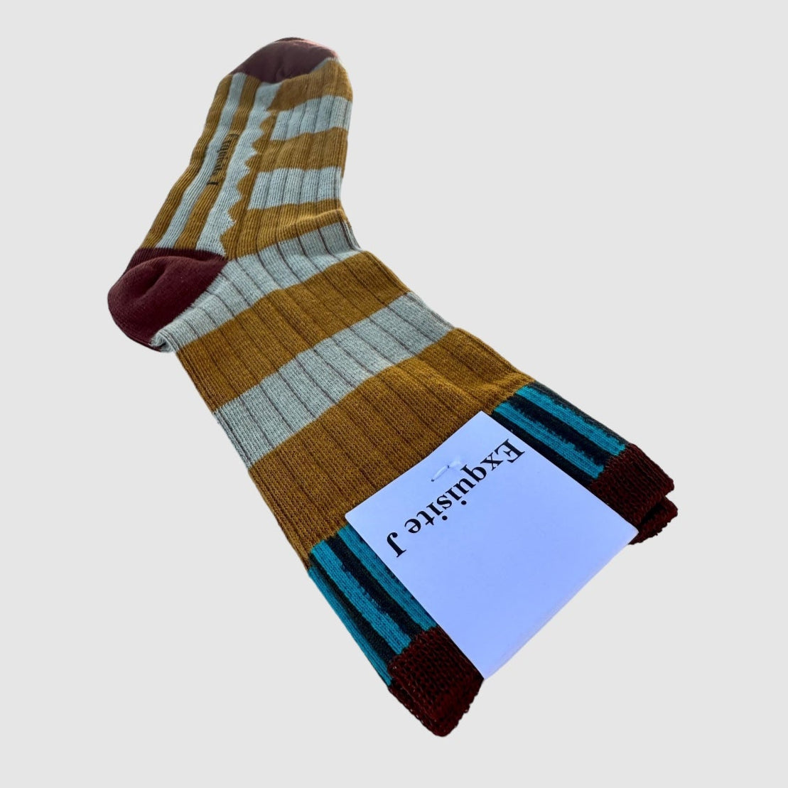 Multicolored striped sock with a label on a light gray background