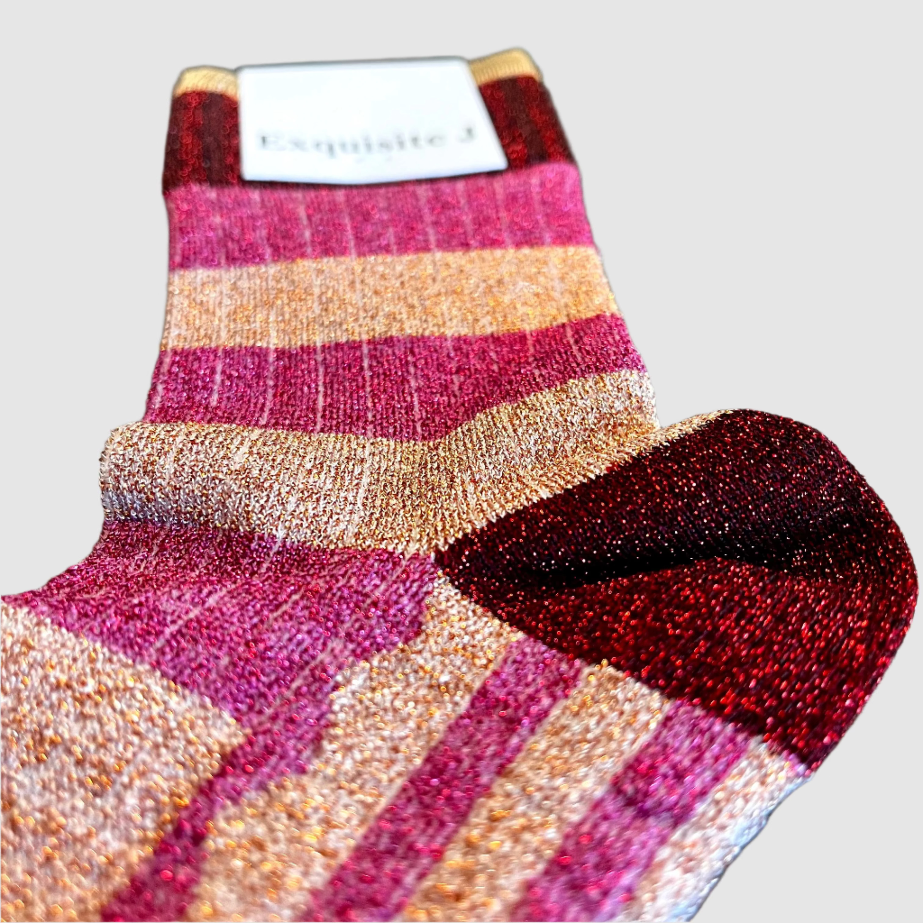 Striped sock with a brand label on a light grey background