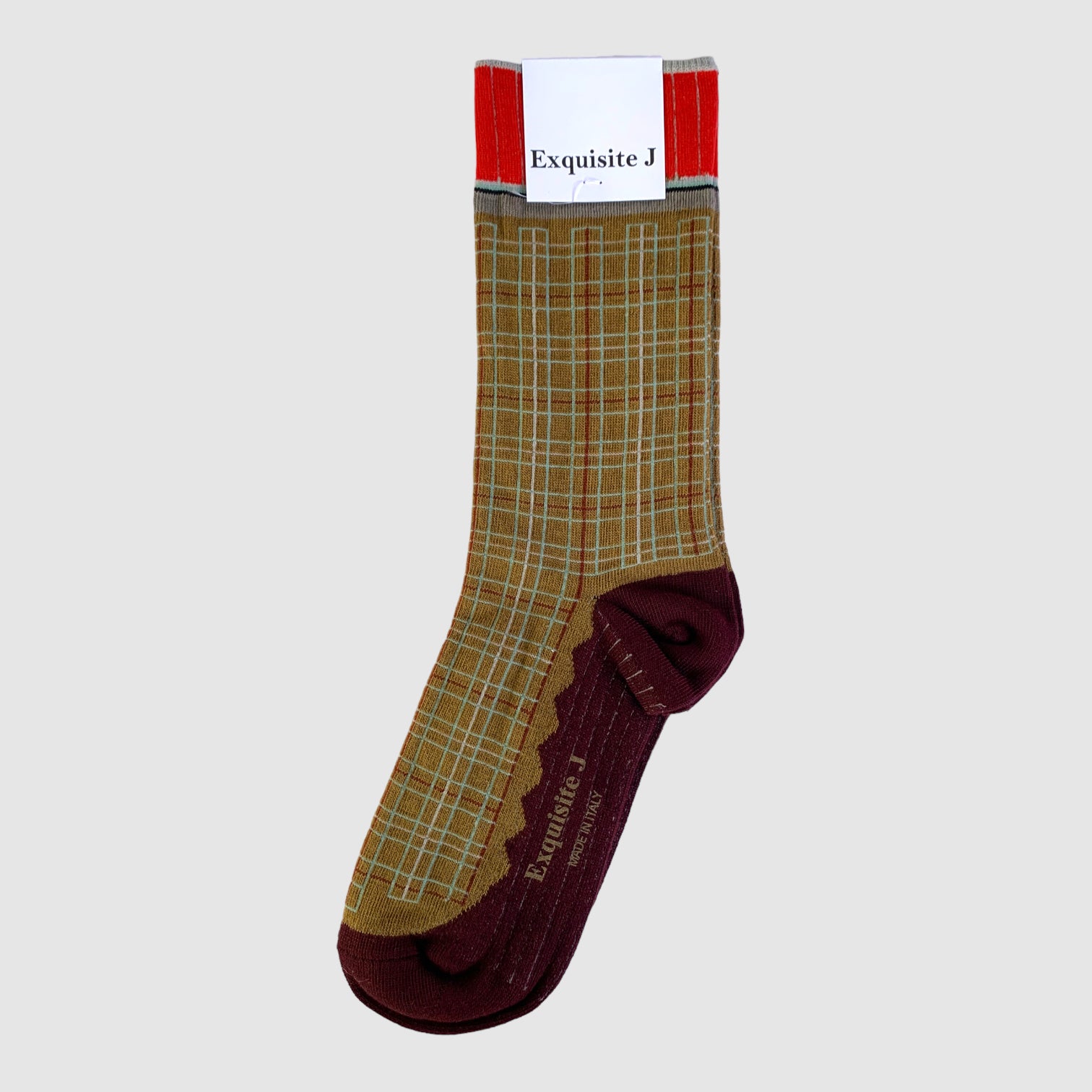 A pair of socks with a geometric pattern, predominantly brown with green and red accents.