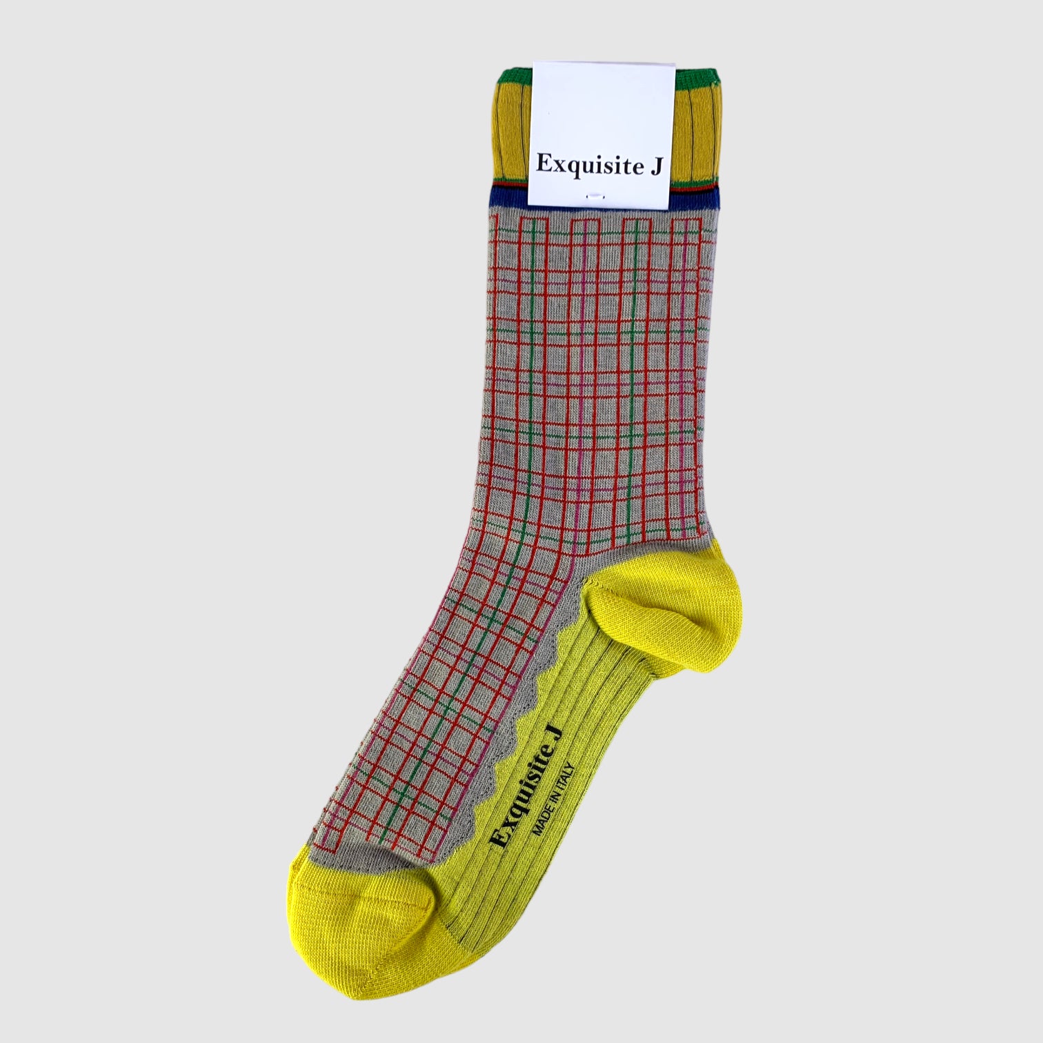 A pair of patterned socks with beige, green, red, and yellow colors, featuring a checkered pattern and solid yellow at the heel and toe, with the brand label 'Exquisite J' visible.