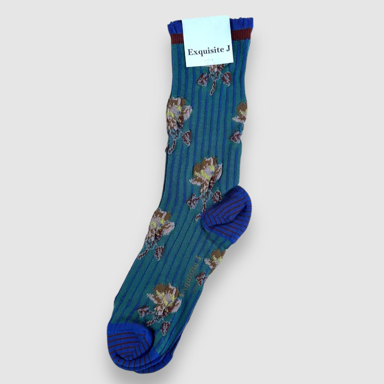 Blue floral-patterned sock with a visible brand label on a light gray background