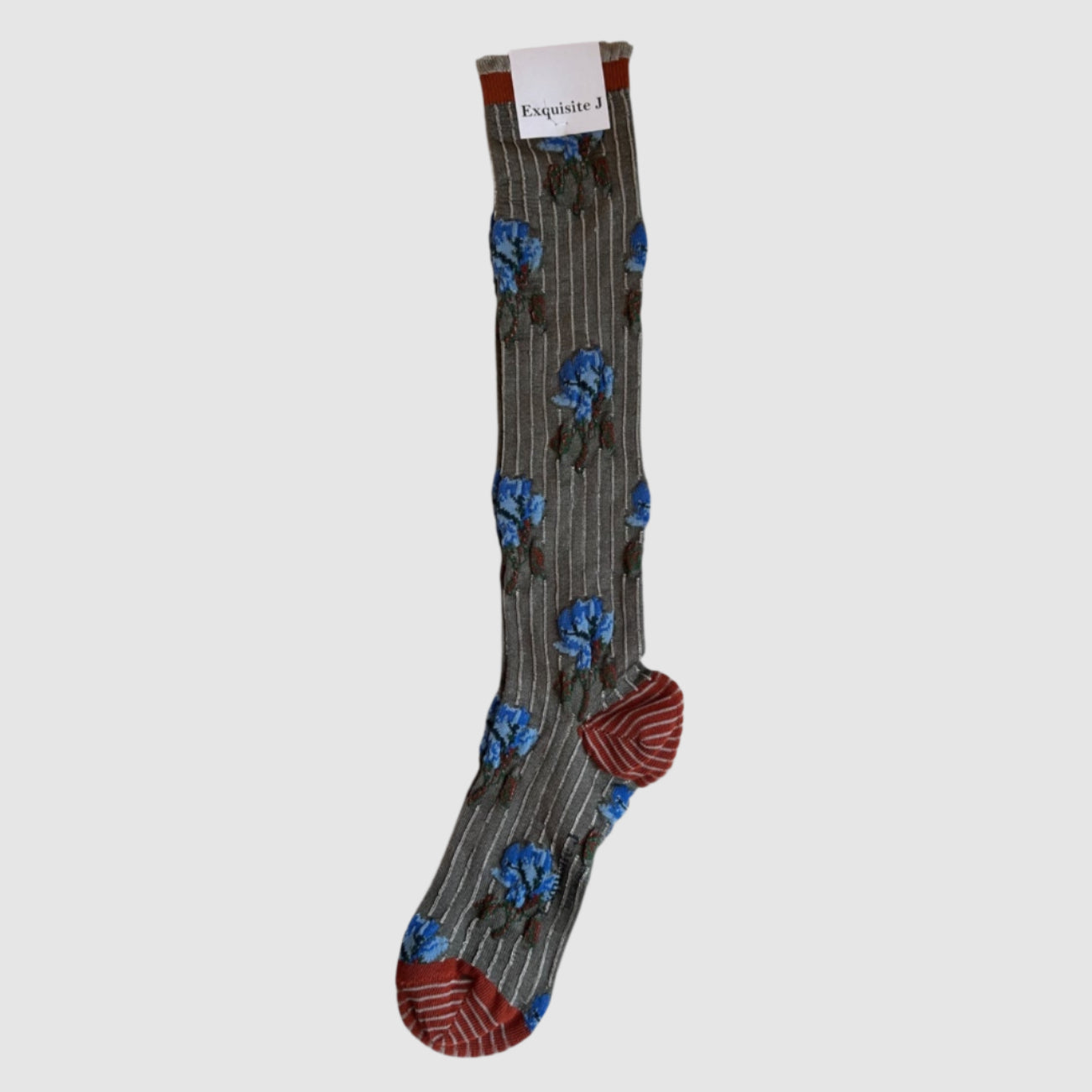 A pair of knee-high socks with a floral pattern in shades of gray, blue, and red displayed against a light grey background.