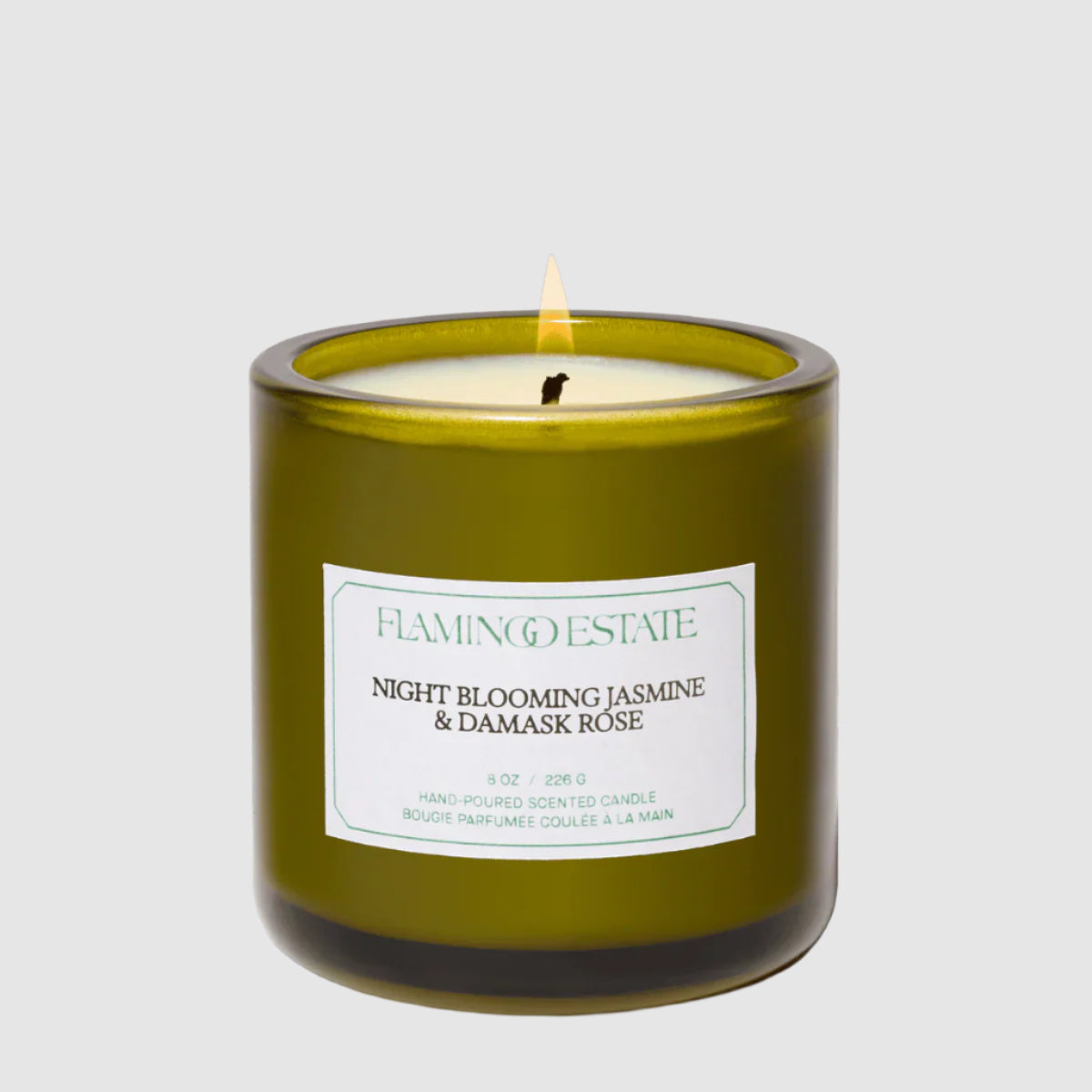 Green candle with a label on a white background