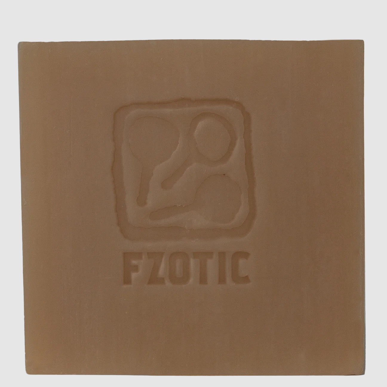 Bar of Toasted Lilac soap from fzotic with logo stamped in the soap on a light grey backghround