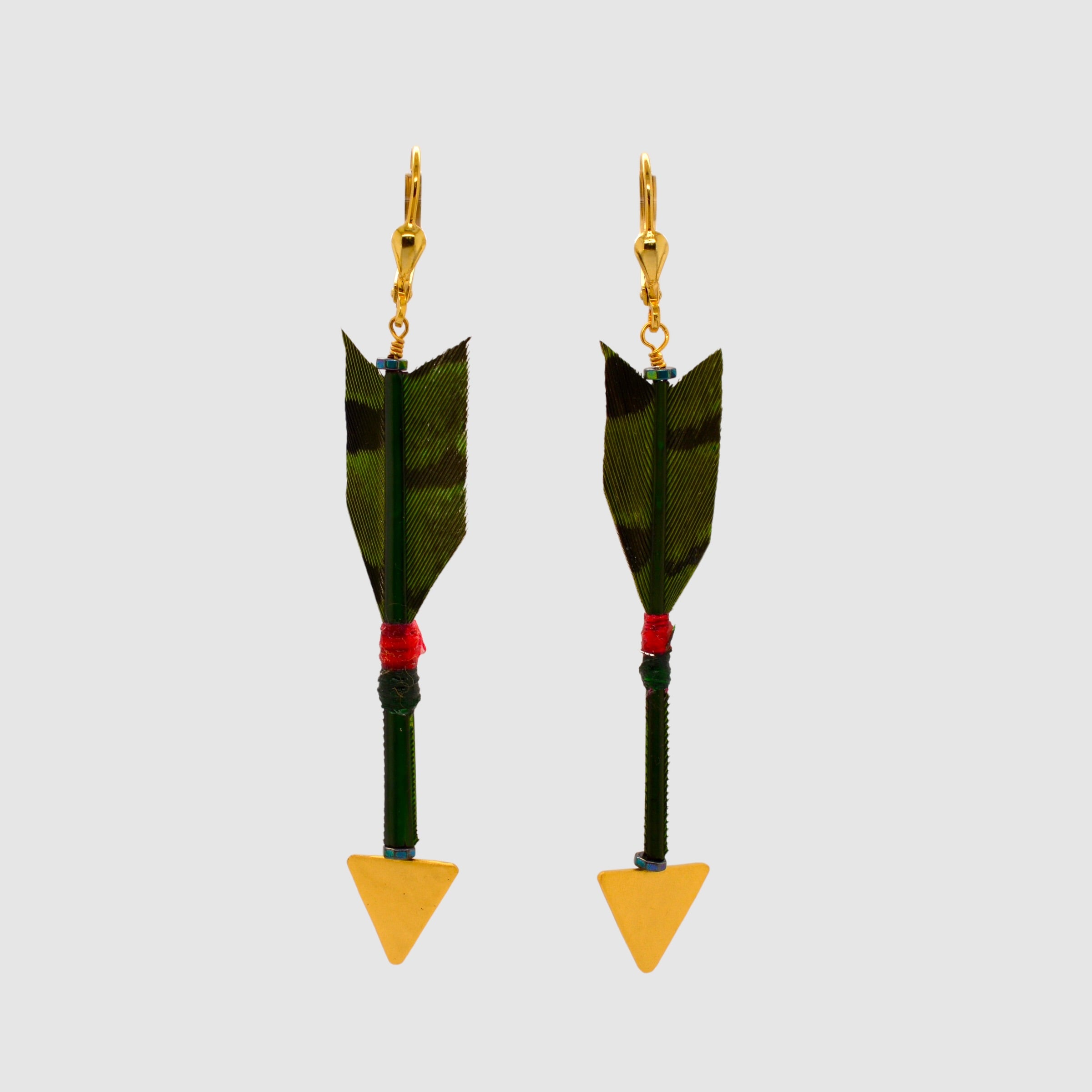 Green pheasant feather arrow earrings with vermeil arrowheads and leverback clasps designed and handmade in Tucson, Arizona by Sofie Albertsen. Displayed on a light grey background.
