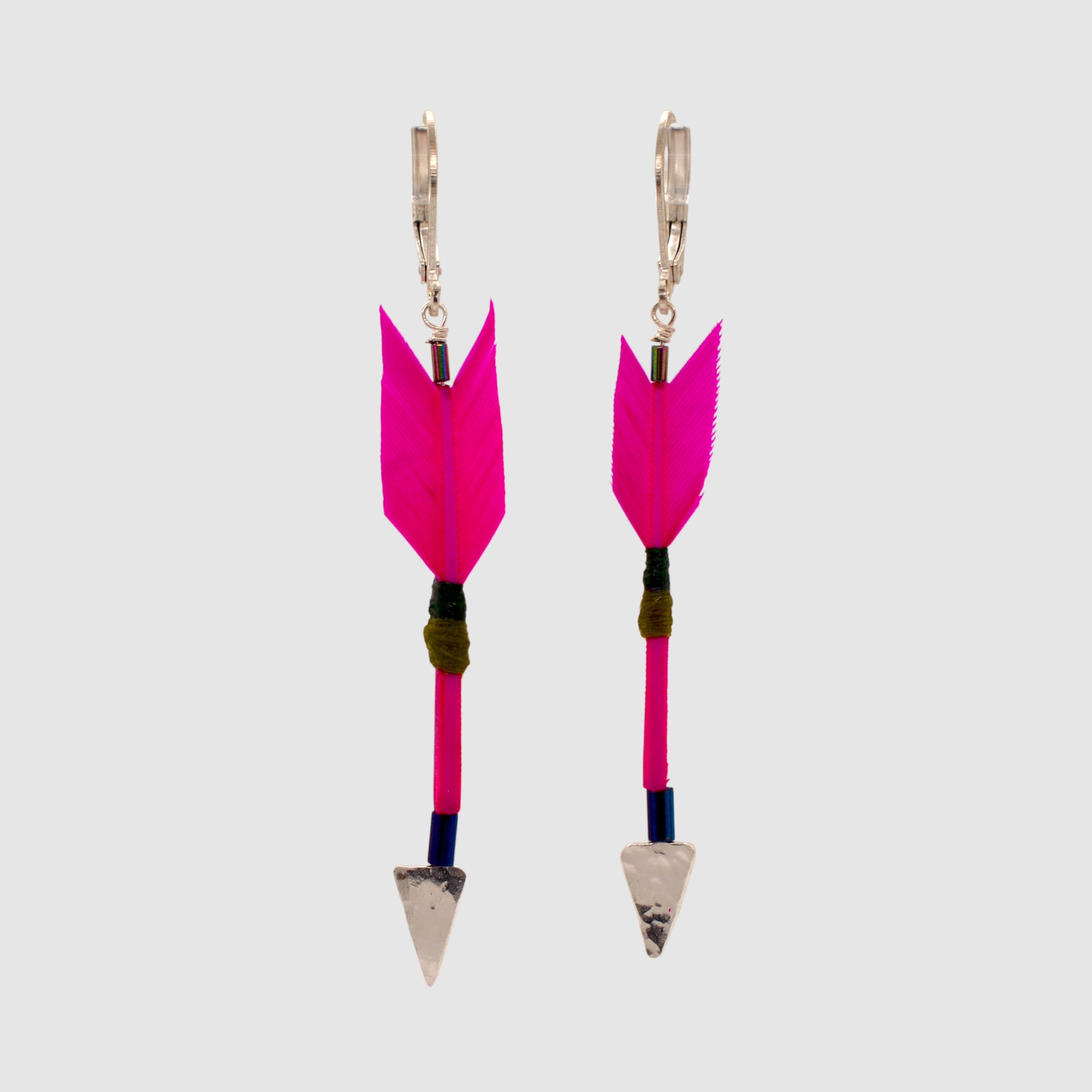 Hot hot pink feather arrow earrings with vermeil arrowheads and leverback clasps designed and handmade in Tucson, Arizona by Sofie Albertsen. Displayed on a light grey background.