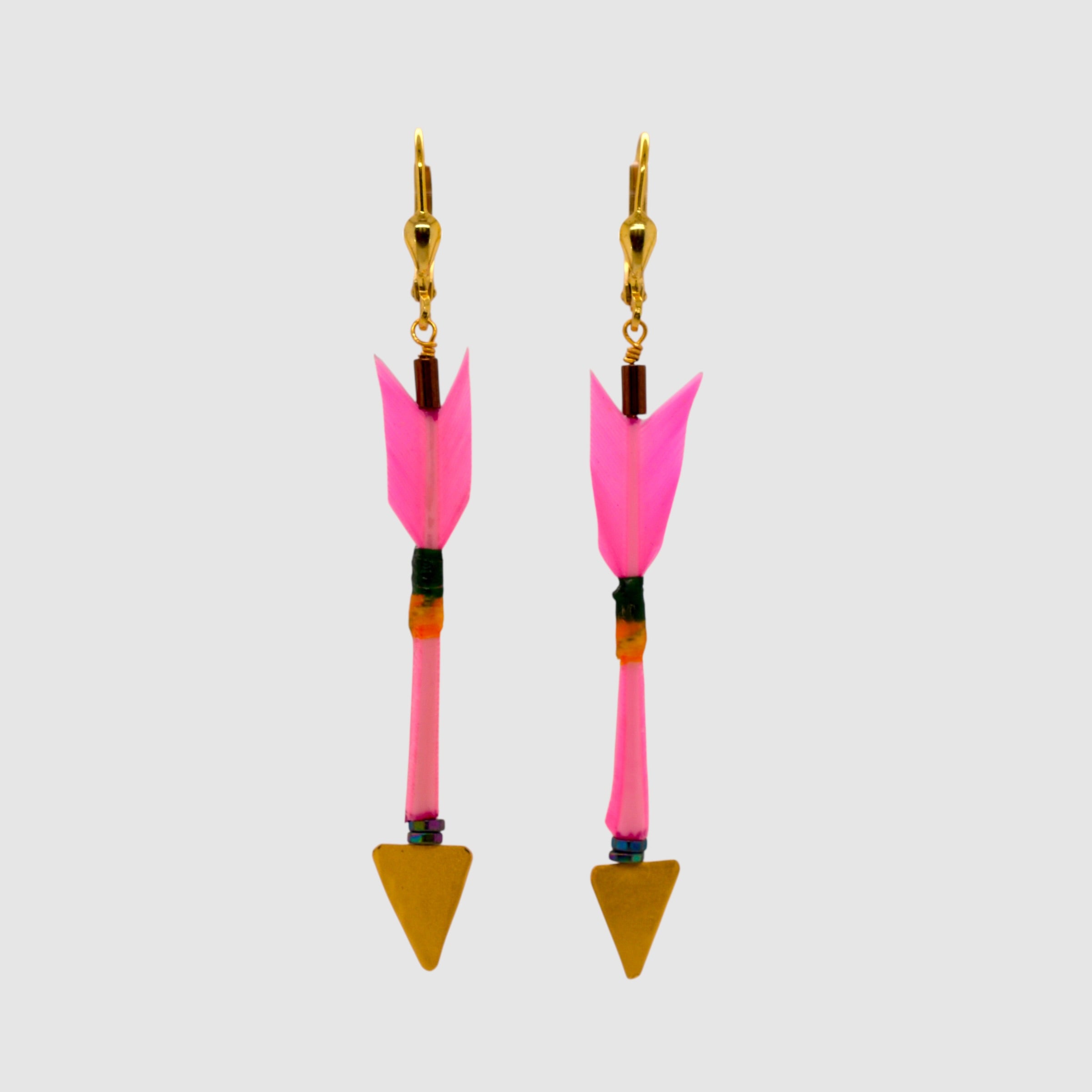 Pink arrow earrings with vermeil arrowheads and leverback clasps designed and handmade in Tucson, Arizona by Sofie Albertsen. Displayed on a light grey background.