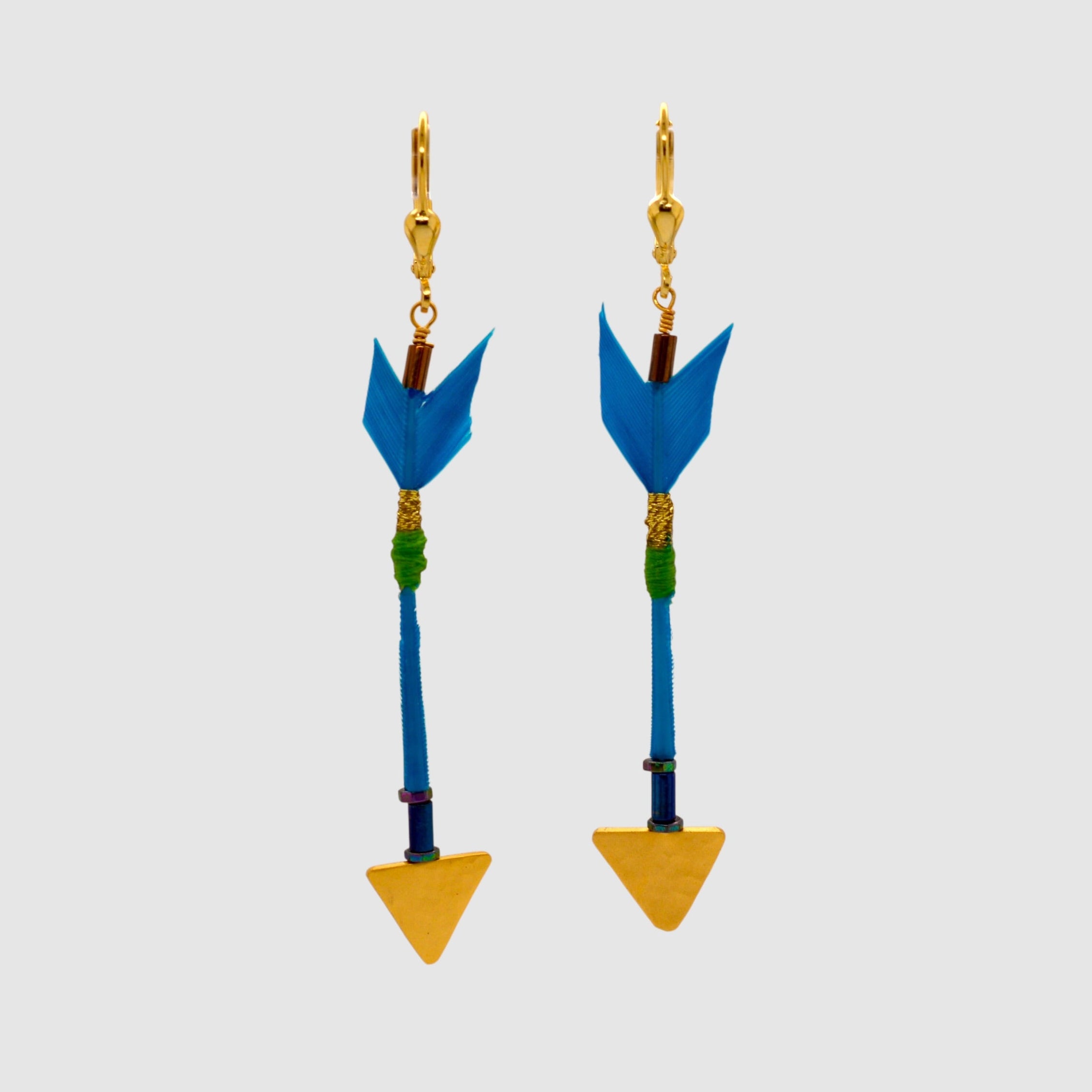 Turquoise feather arrow earrings with vermeil arrowheads and leverback clasps designed and handmade in Tucson, Arizona by Sofie Albertsen. Displayed on a light grey background.