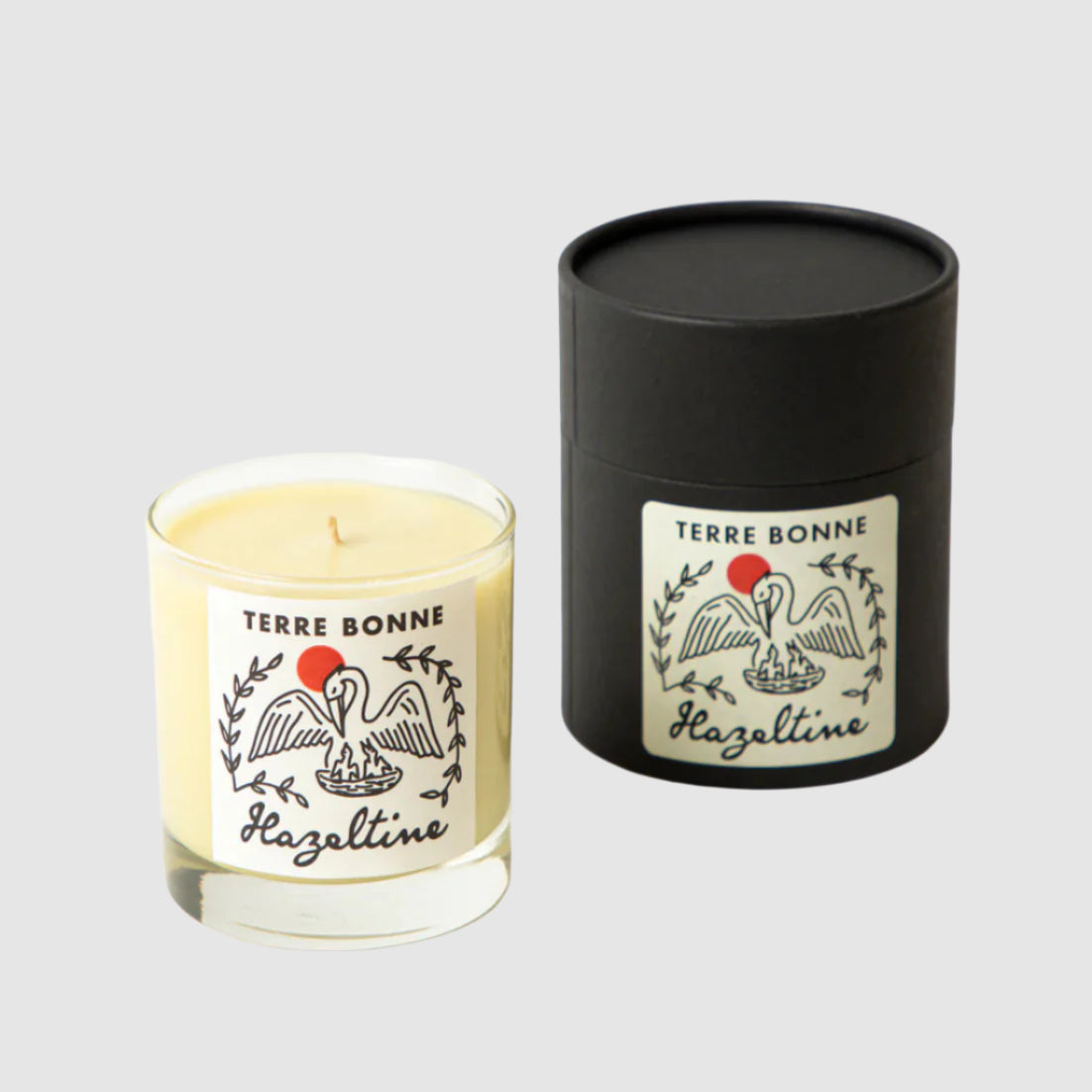 Candle and black cylindrical container with 'Terre Bonne' branding on a white background