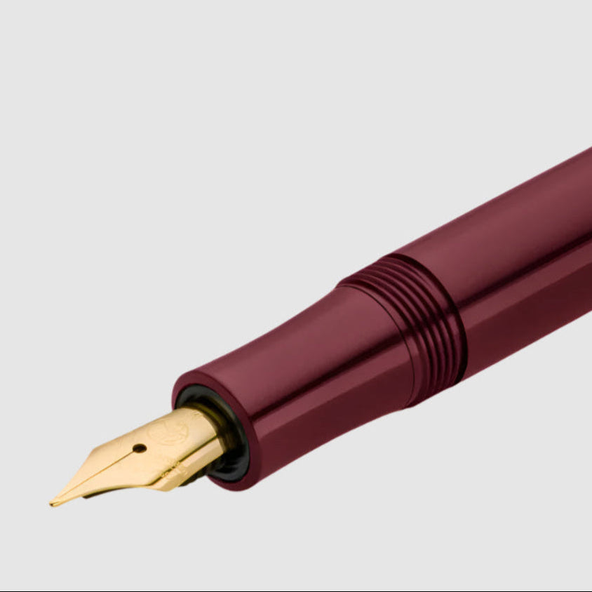 Maroon fountain pen with gold nib on a white background