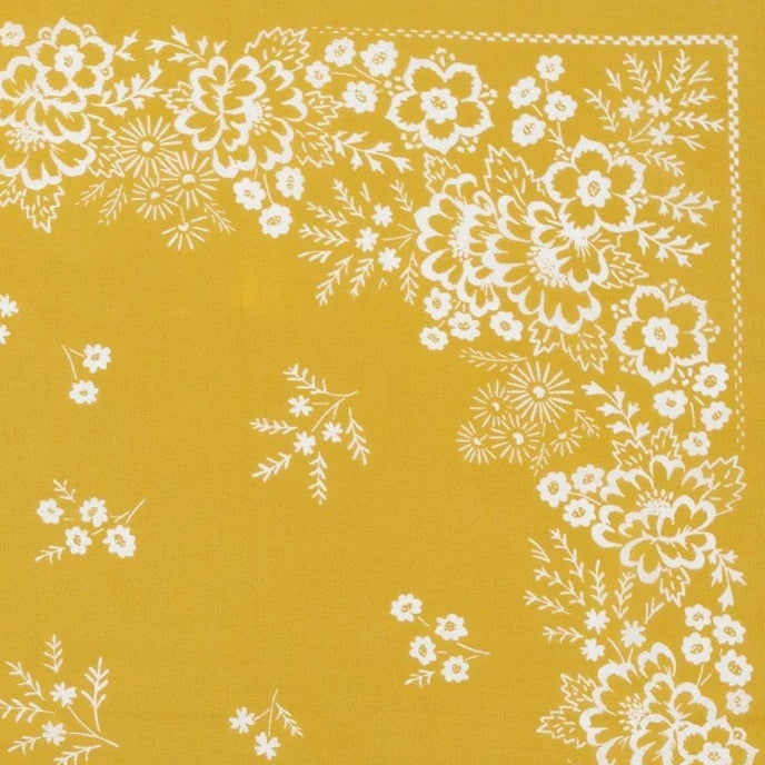 Close up of a yellow Last Chance bandana with white floral pattern