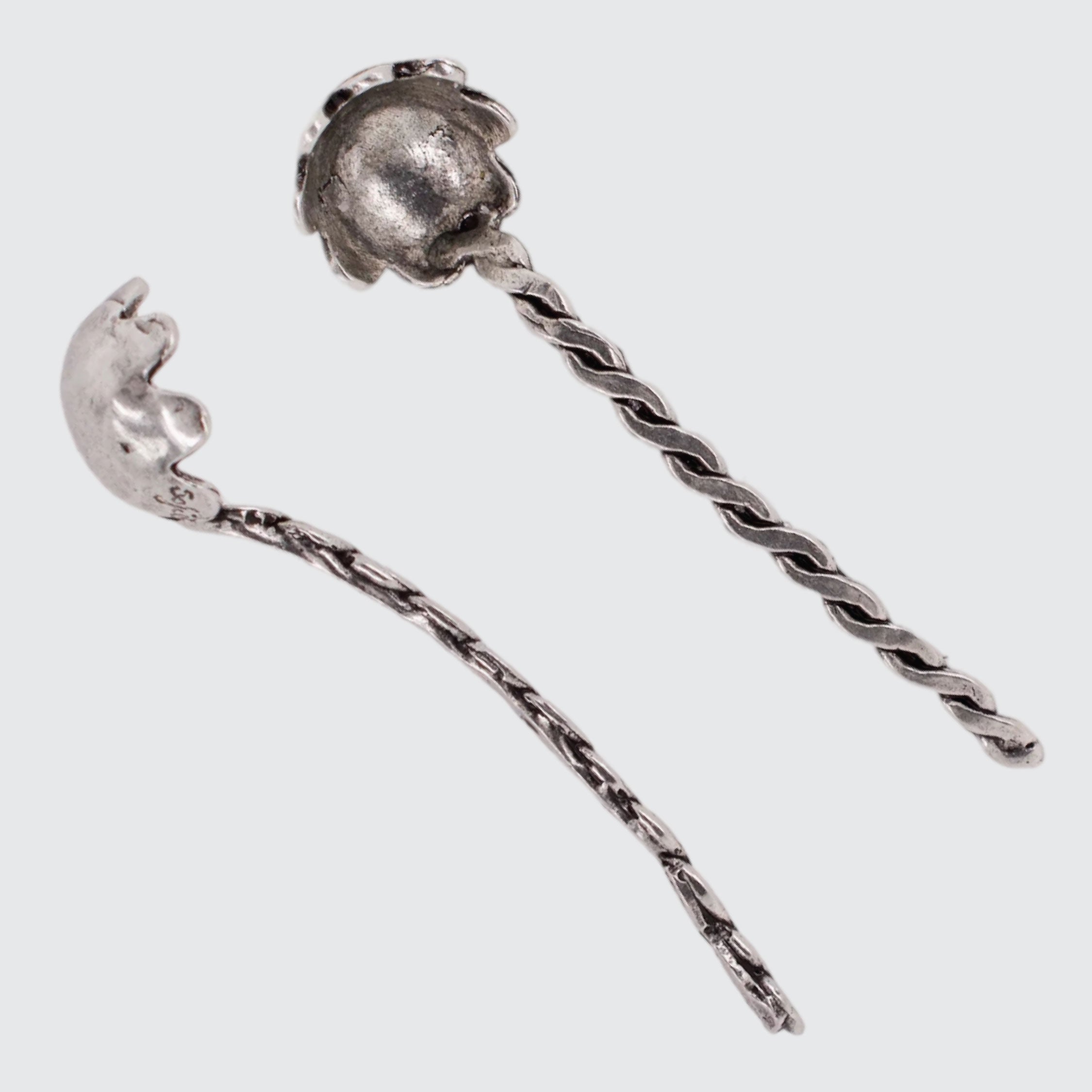 Silver hairpin with twisted design on a light gray background