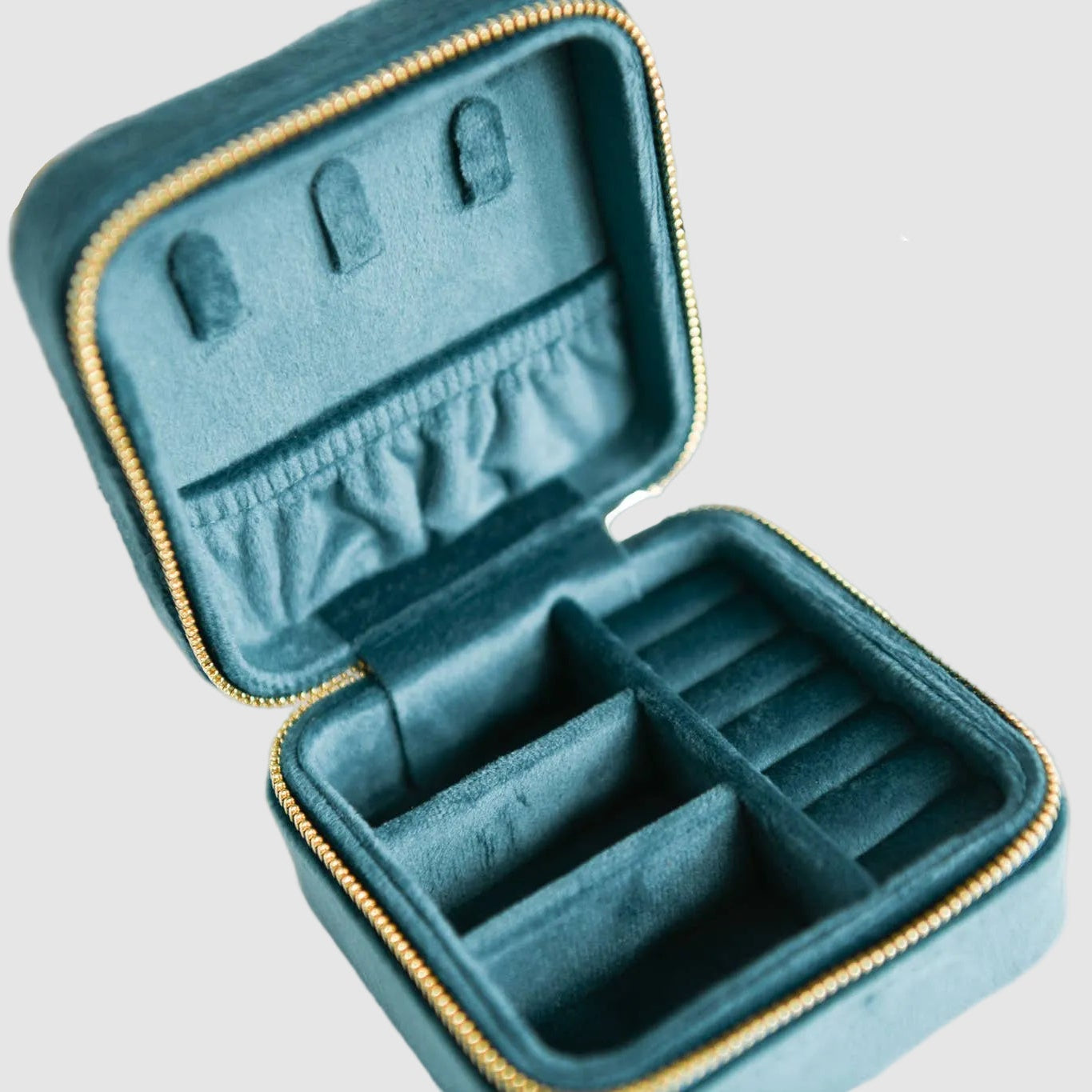 Teal, velvet, Cecelia Designs jewelry travel case with compartments for rings, bracelets, necklaces, on a light background. The perfect, unique gift for a jewelry lover.