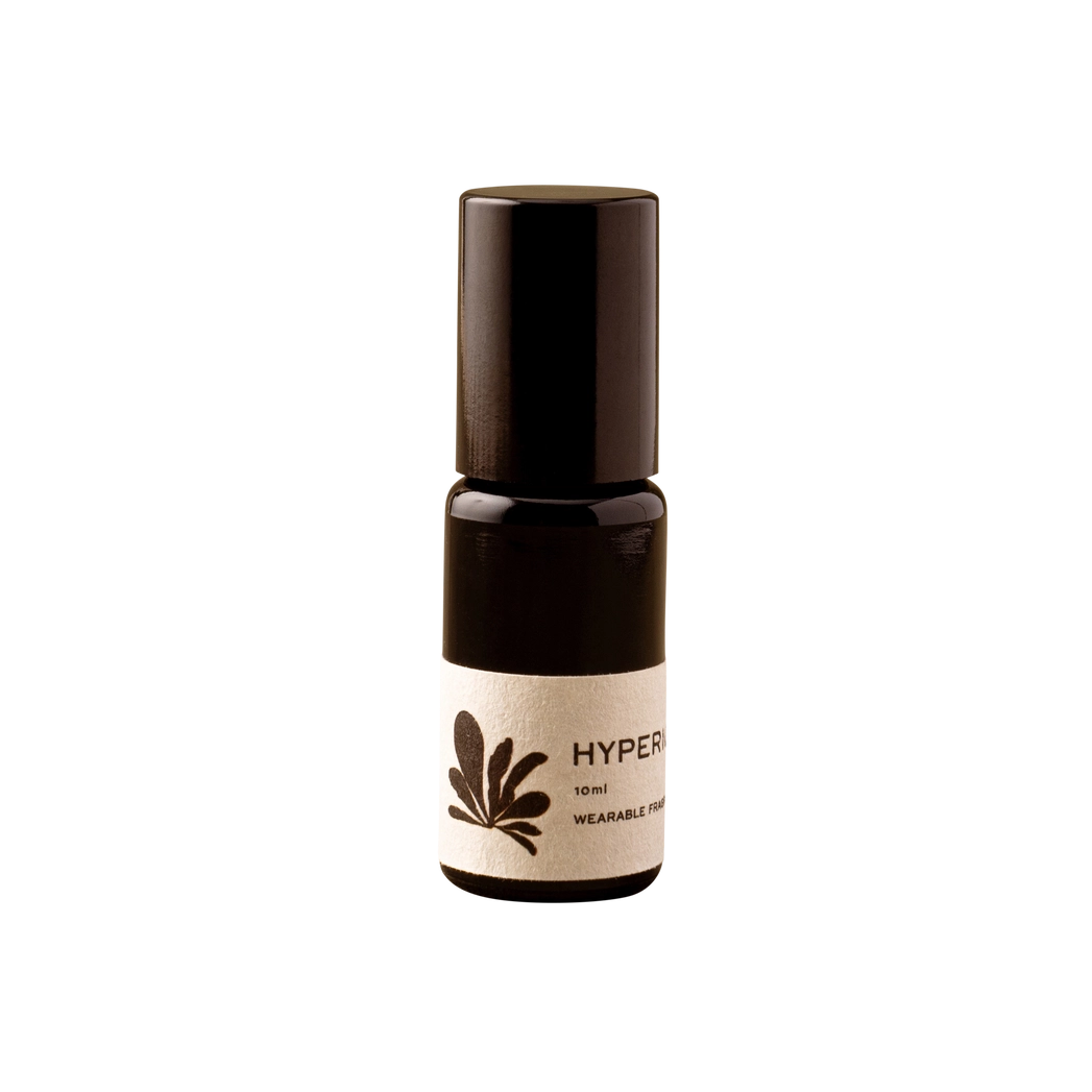 A small dark amber glass roller bottle with a black cap and a cream-colored label featuring a dark leaf graphic and the partial text 'HYPER.