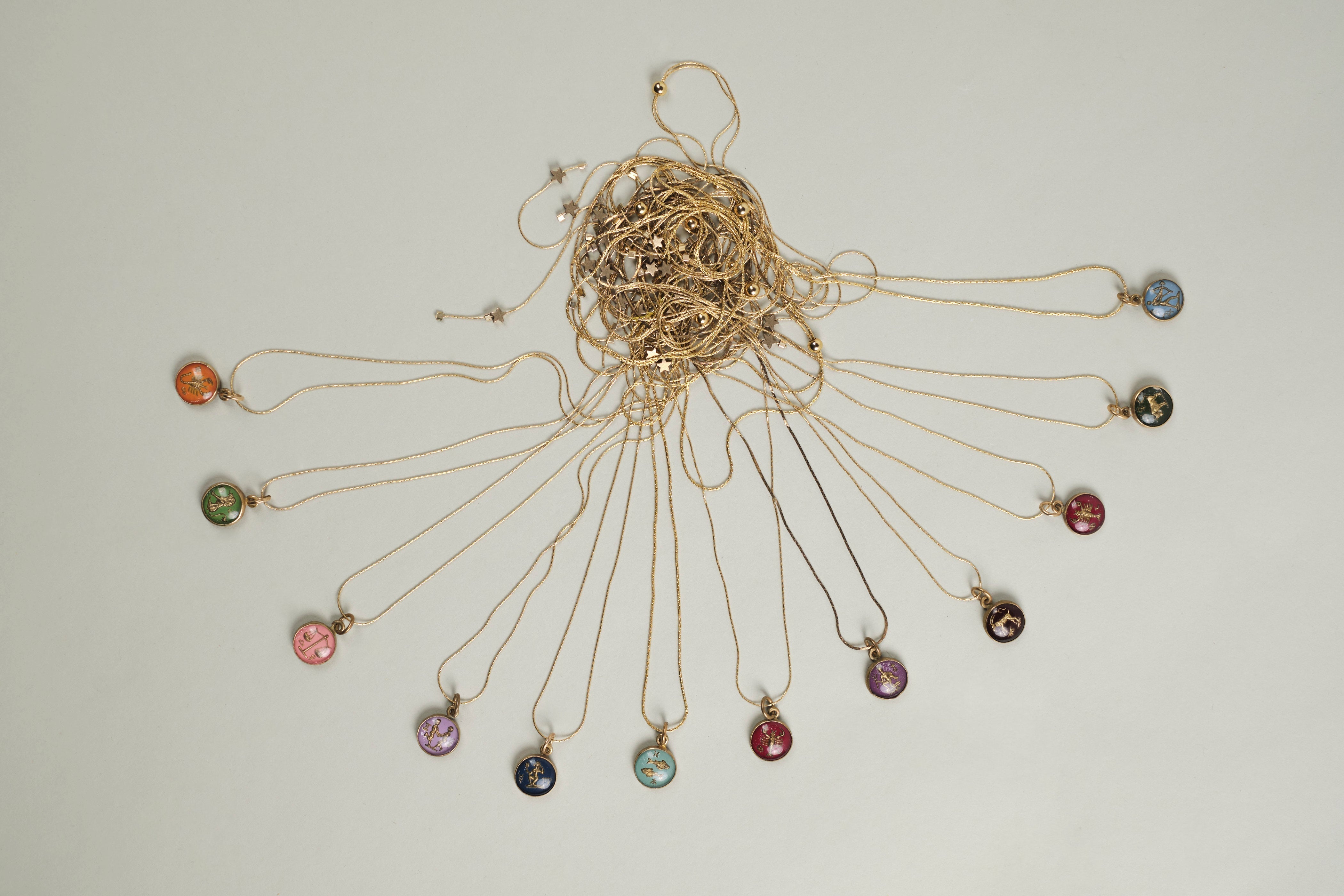 Full set of 'In The Stars' Astrological necklaces handmade by Tasha Bundy featuring Aries, Taurus, Gemini, Cancer, Leo, Virgo, Libra, Scorpio, Sagittarius, Capricorn, Aquarius, and Pisces.