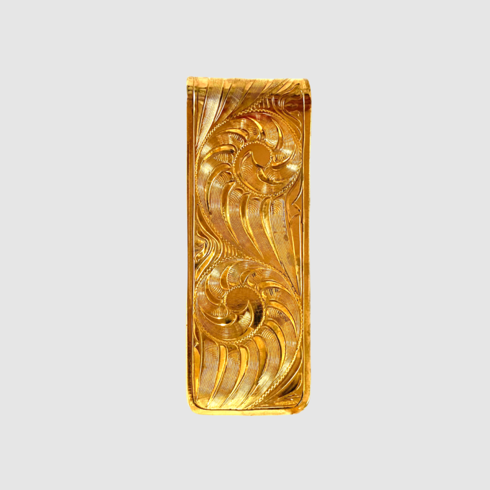 Gold money clip with intricate design on a white background