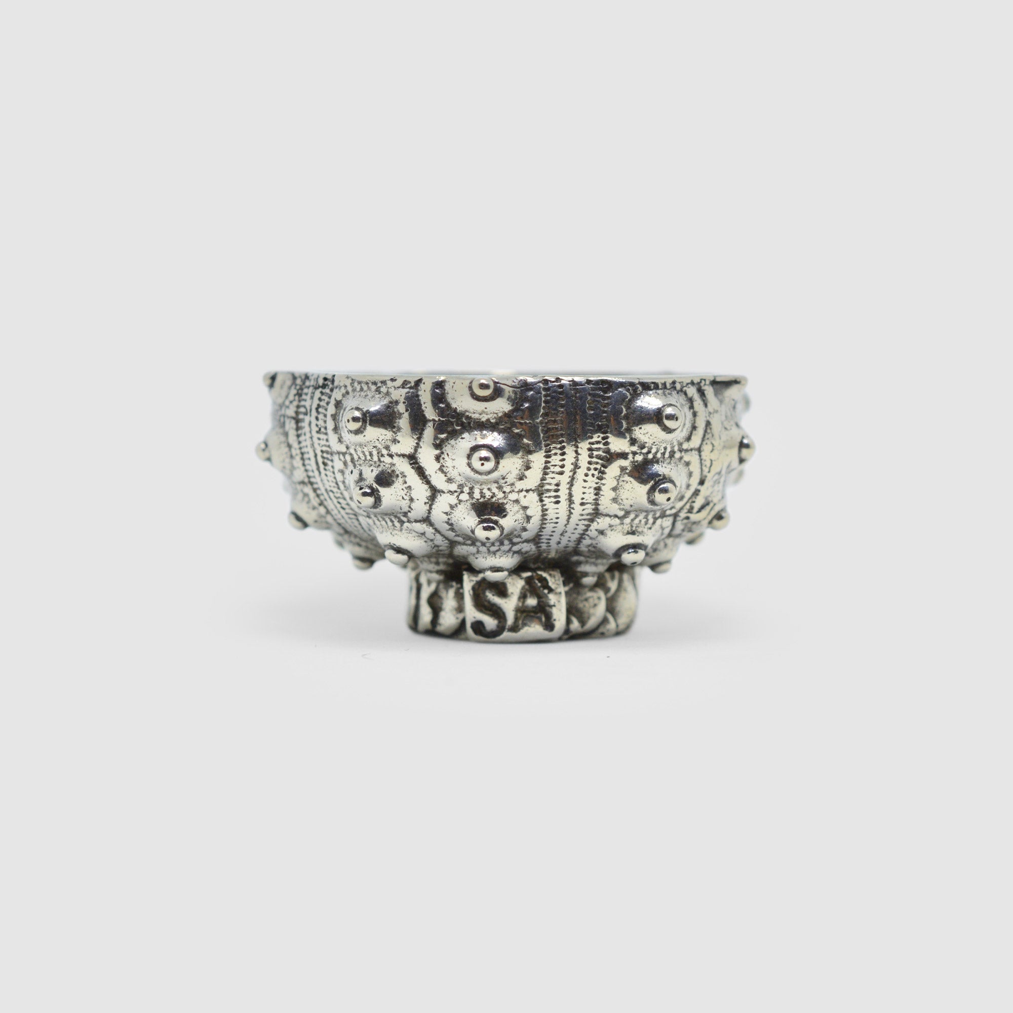 A small, decorative pewter bowl with a sea urchin design, made in Tucson, displayed against a white background.