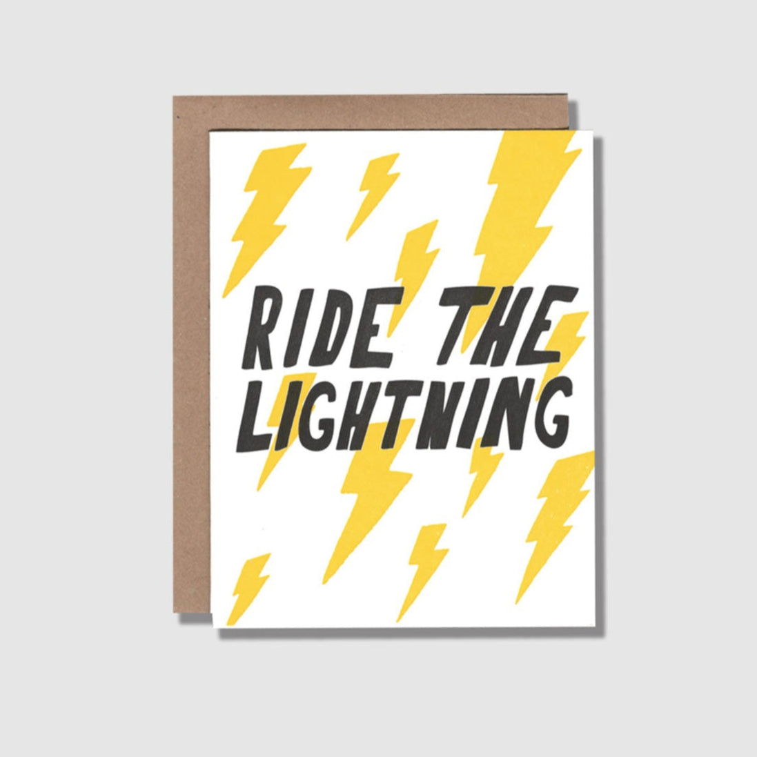 Front view of a greeting card with yellow lightning bolts printed on a white card. "Ride the lightining" is across the center middle.