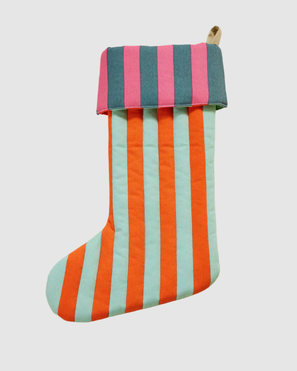 Front view of a quilted cotton holiday stocking with fabric loop for hanging. Striped, multi colored pattern on each featuring light teal, orange, pink, and dark teal. 