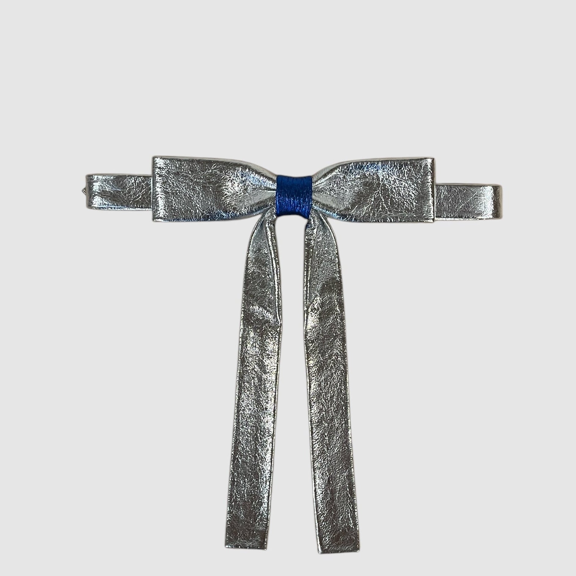 Silver metallic bow on a light gray background