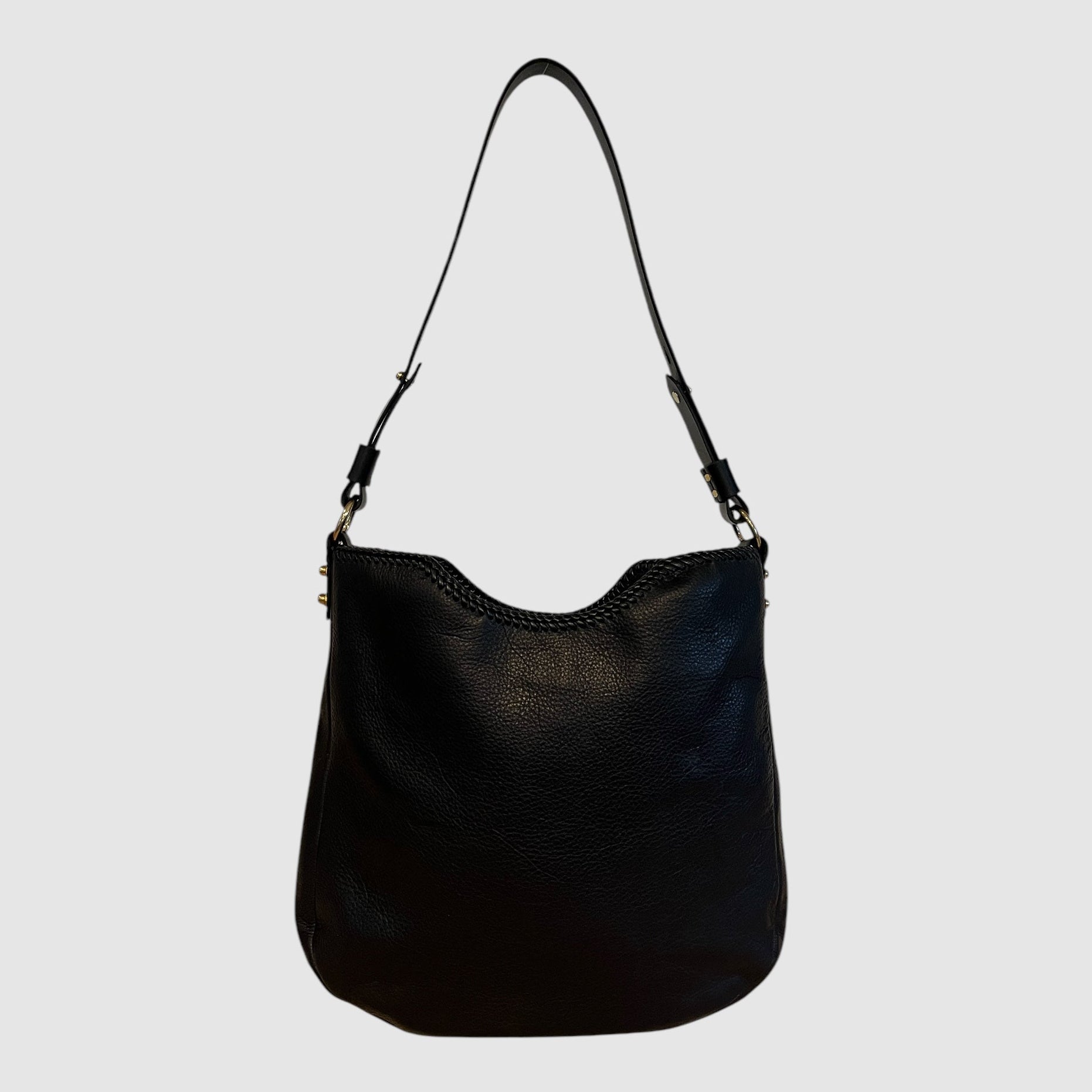 This image features the "OUTSIDER SHOULDER // BLACK // SINGLE STRAP" handbag, elegantly crafted from black leather with a smooth finish. The bag displays a sleek design with a single black leather strap, adjustable from 14 inches to 17 inches in length, adding versatility to the carry options.