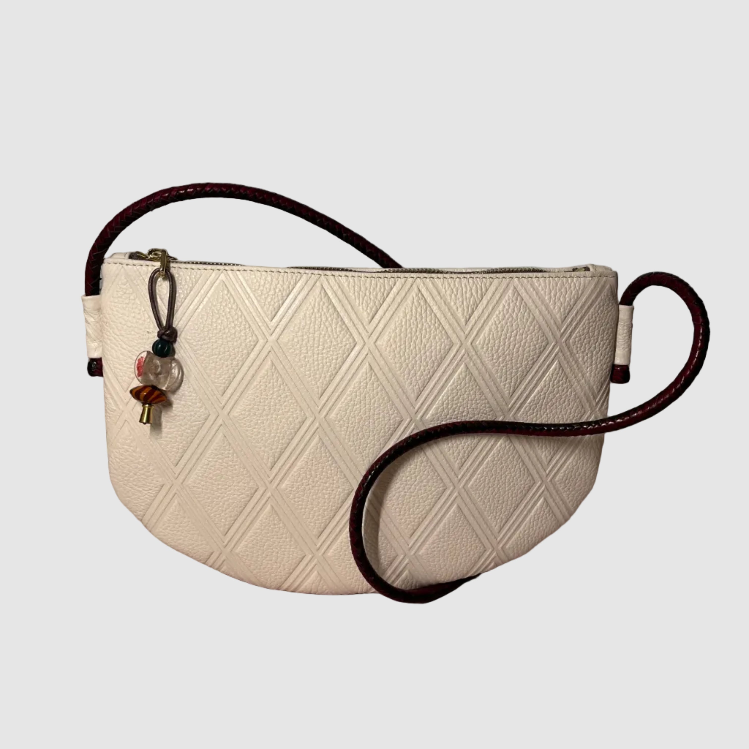 quilted white leather crossbody bag with hand braided leather strap in black and fuscia
