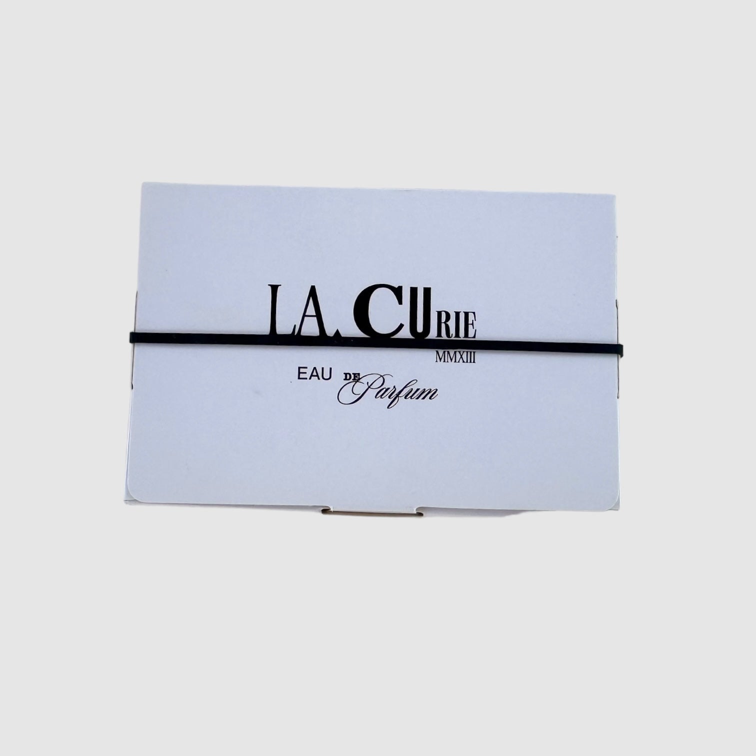 back view of LA CURIE's sample set. Logo  reading "LA CURIE, MMXIII, EAU DE Parfum". 