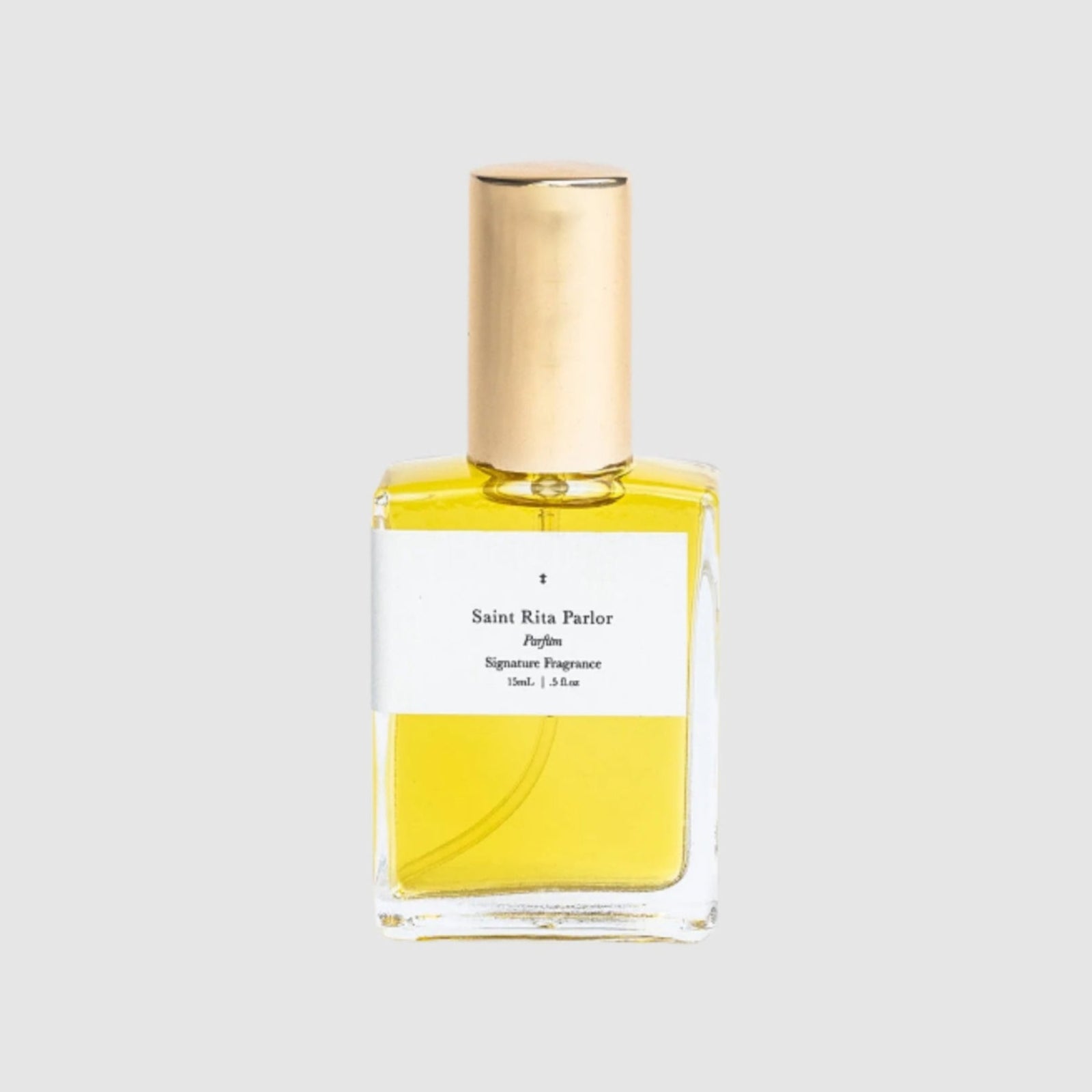 Perfume bottle with gold cap and yellow label on a white background